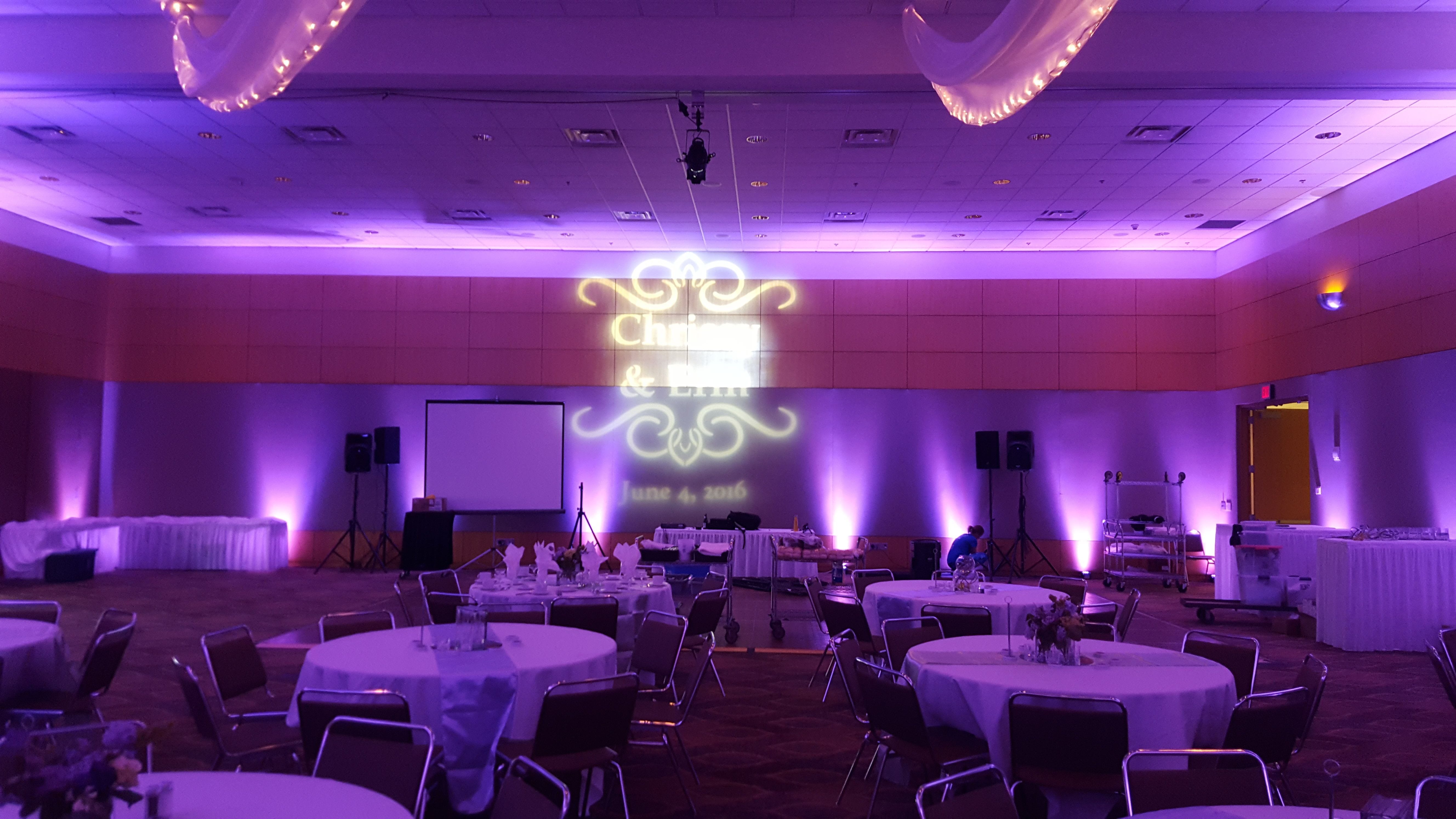 Wedding lighting in the Horizon Room at the DECC. Up lighting in lavender with a wedding monogram.