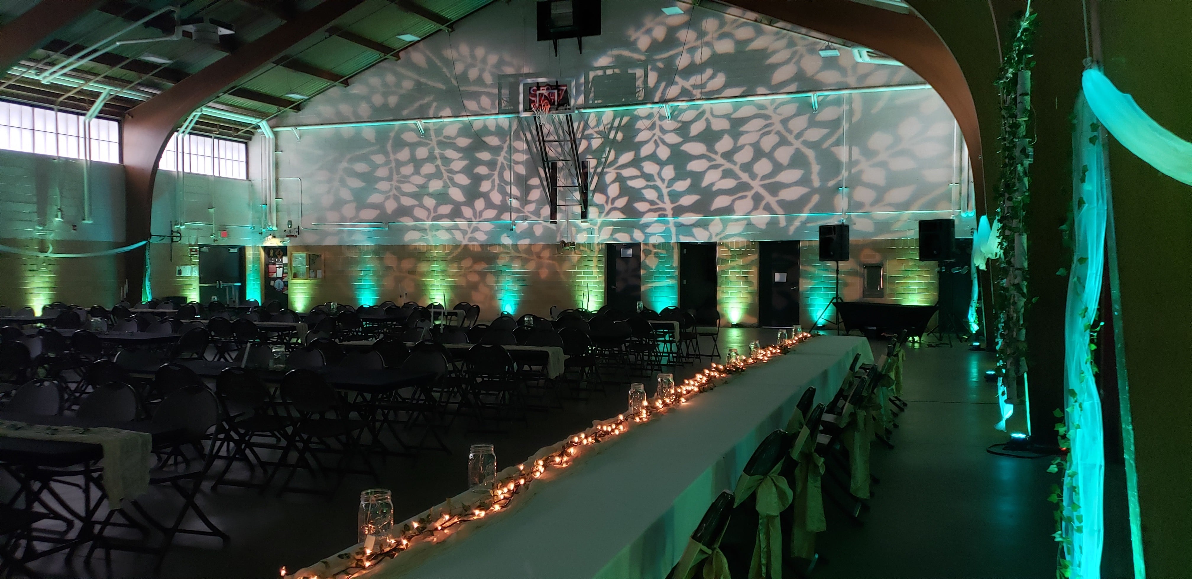 Two tone green up lighting with leaf gobos for a Midsummer Night's Dream themed wedding