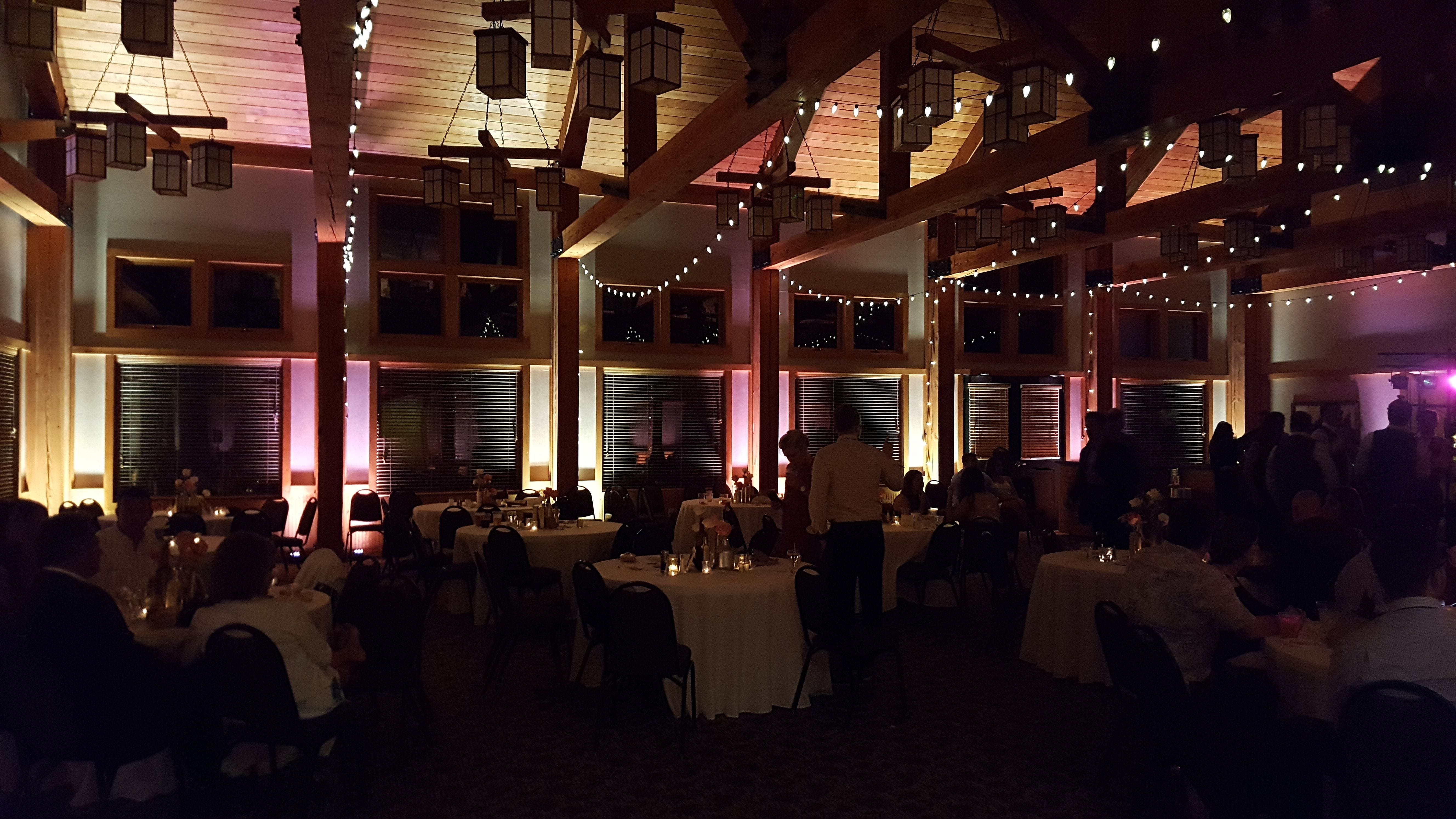 Wedding lighting at the Heartwood Resort in Trego, WI. Up lighting in rose gold and warm white with bistro.