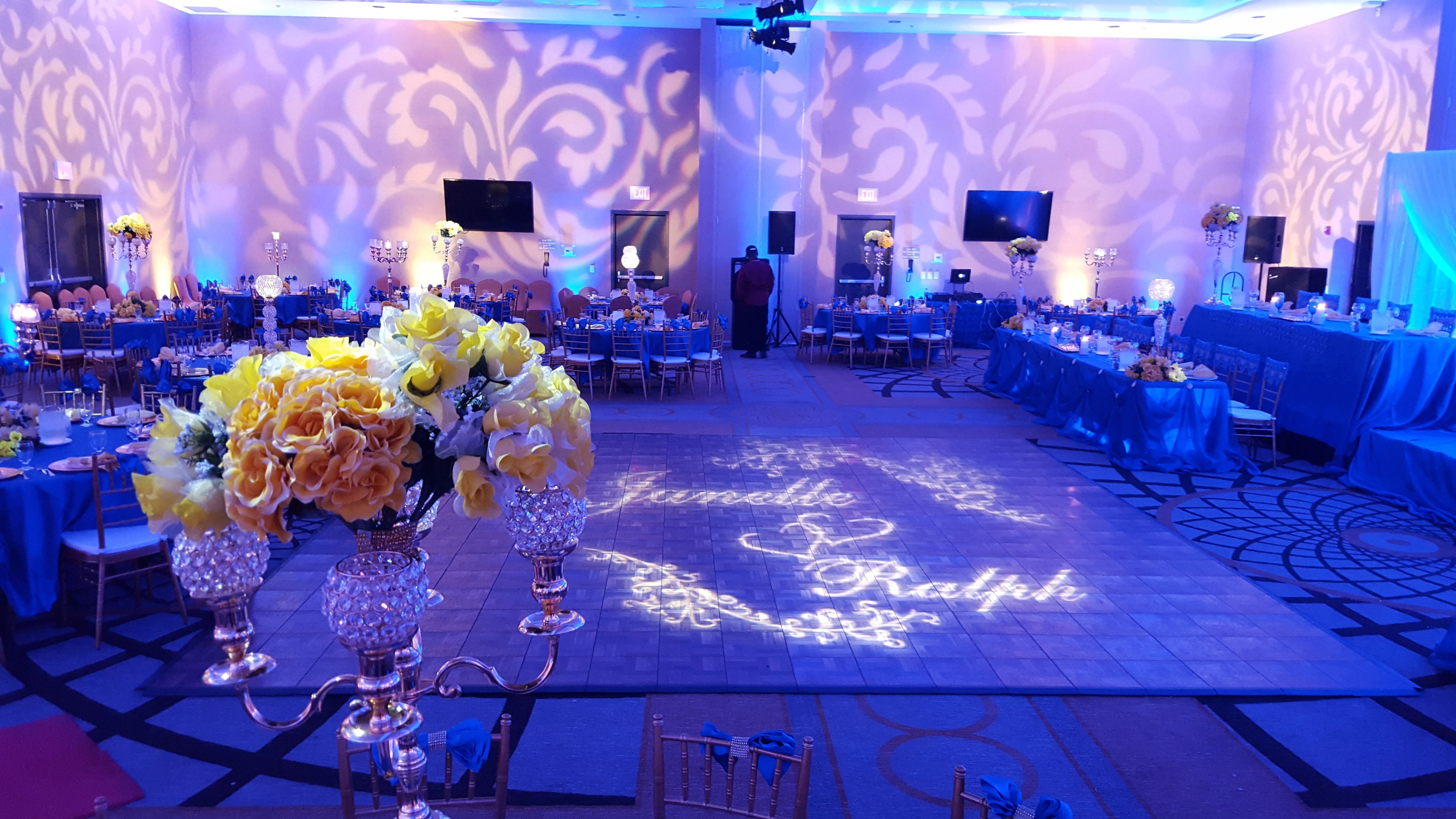 Wedding lighting with a monogram and fancy gobos on the walls. Pin spots.