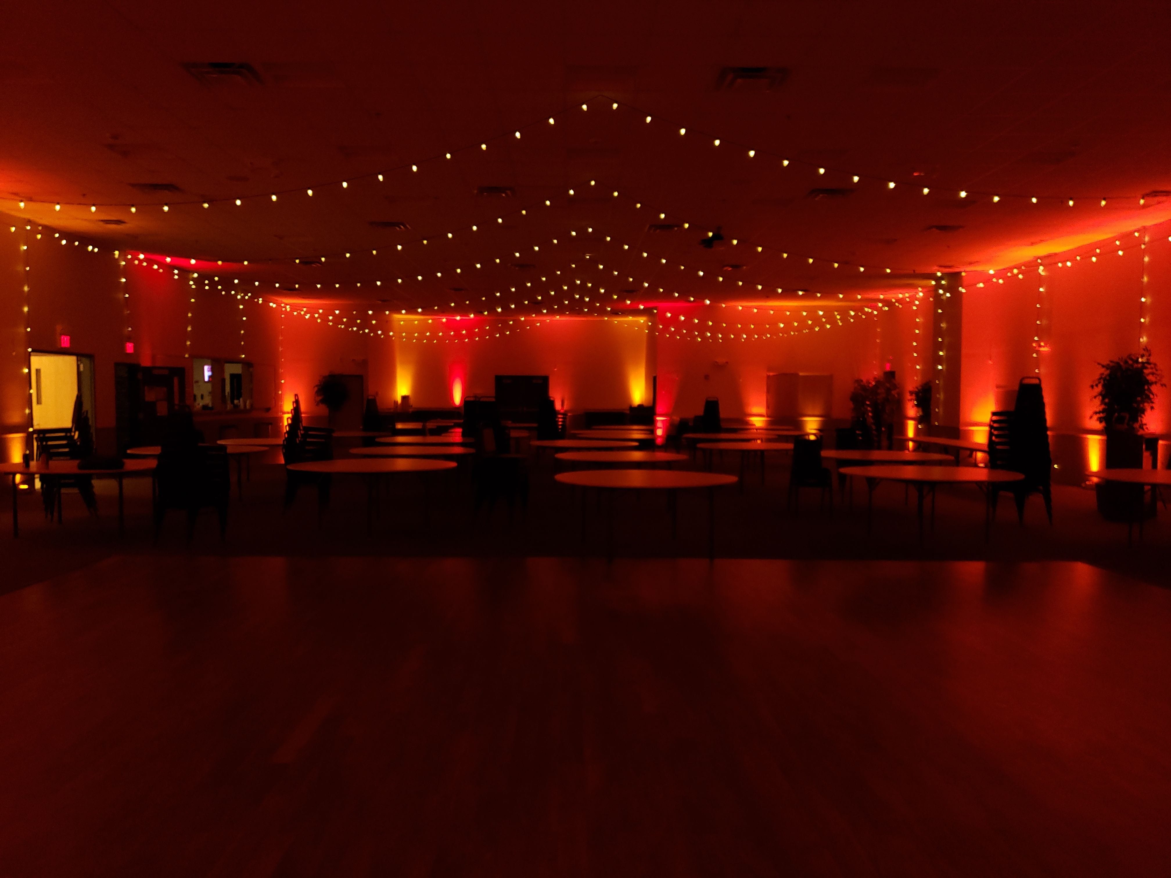 Wedding lighting at the AAD Shrine by Duluth Event lightingith red and amber up lighting and bistro