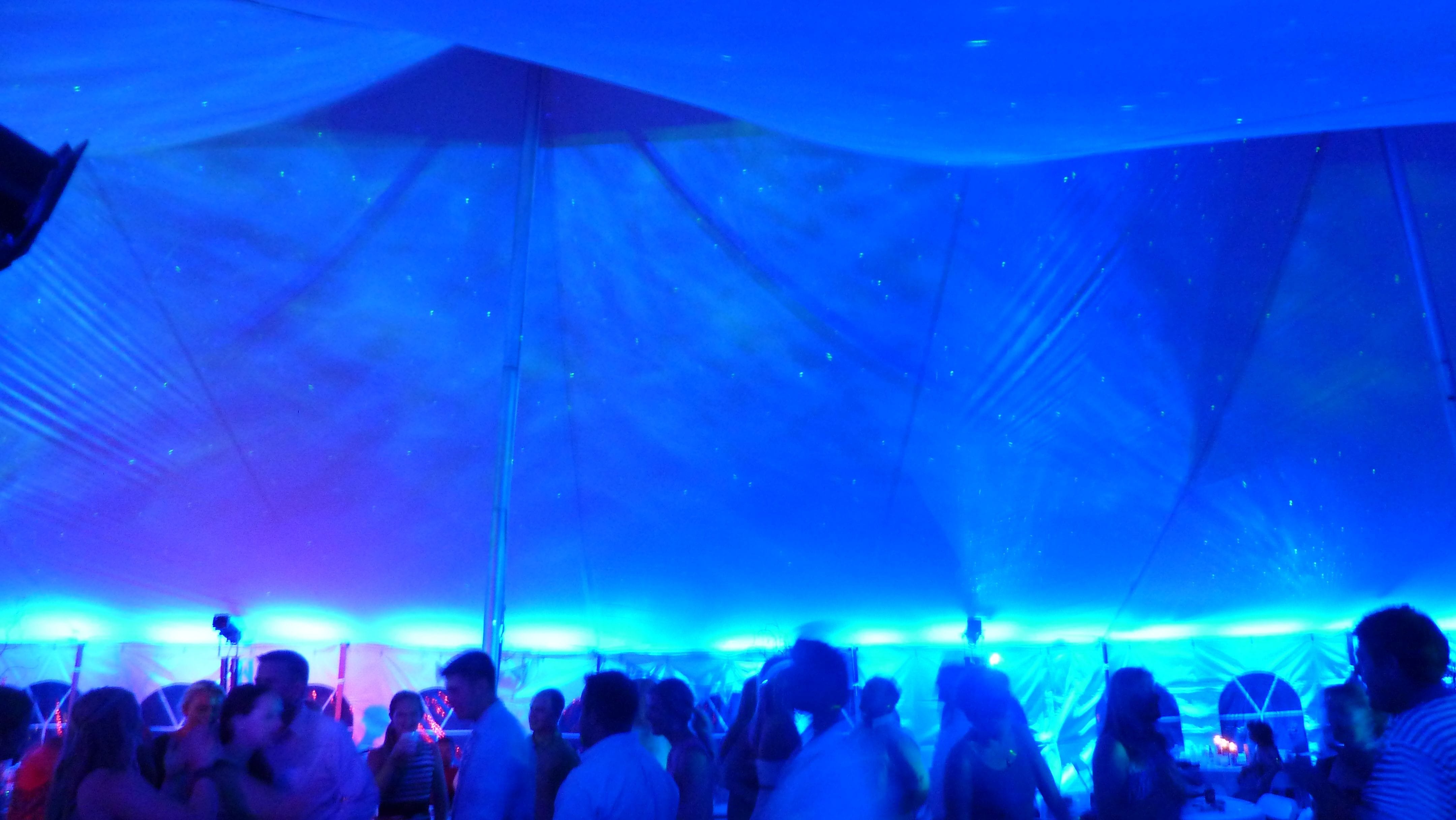 Tent wedding lighting. Up lighting in blue. Stars and Northern Lights dancing on the ceiling.