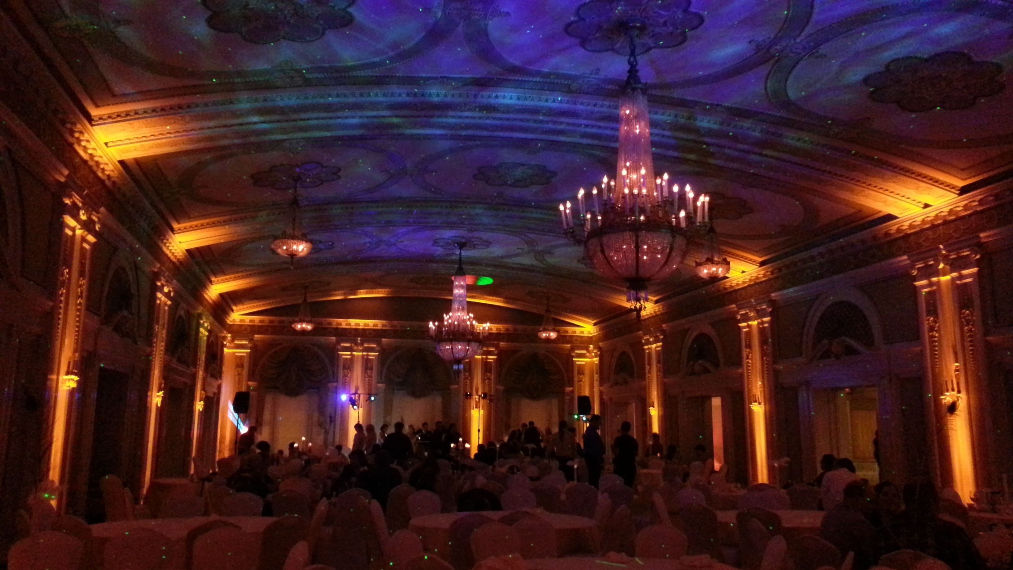 Wedding lighting at Greysolon Ballroom. Up lighting in amber with stars and Northern Lights dancing on the ceilnig.