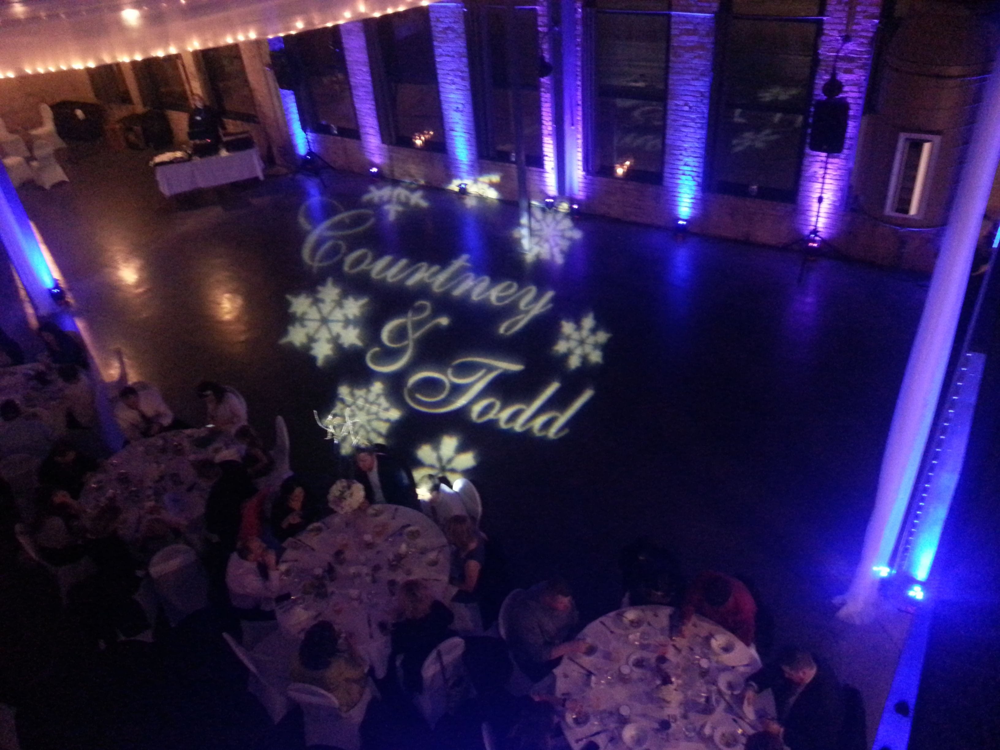 Wedding lighting at Clyde. Up lighting in blue and purple with a monogram.