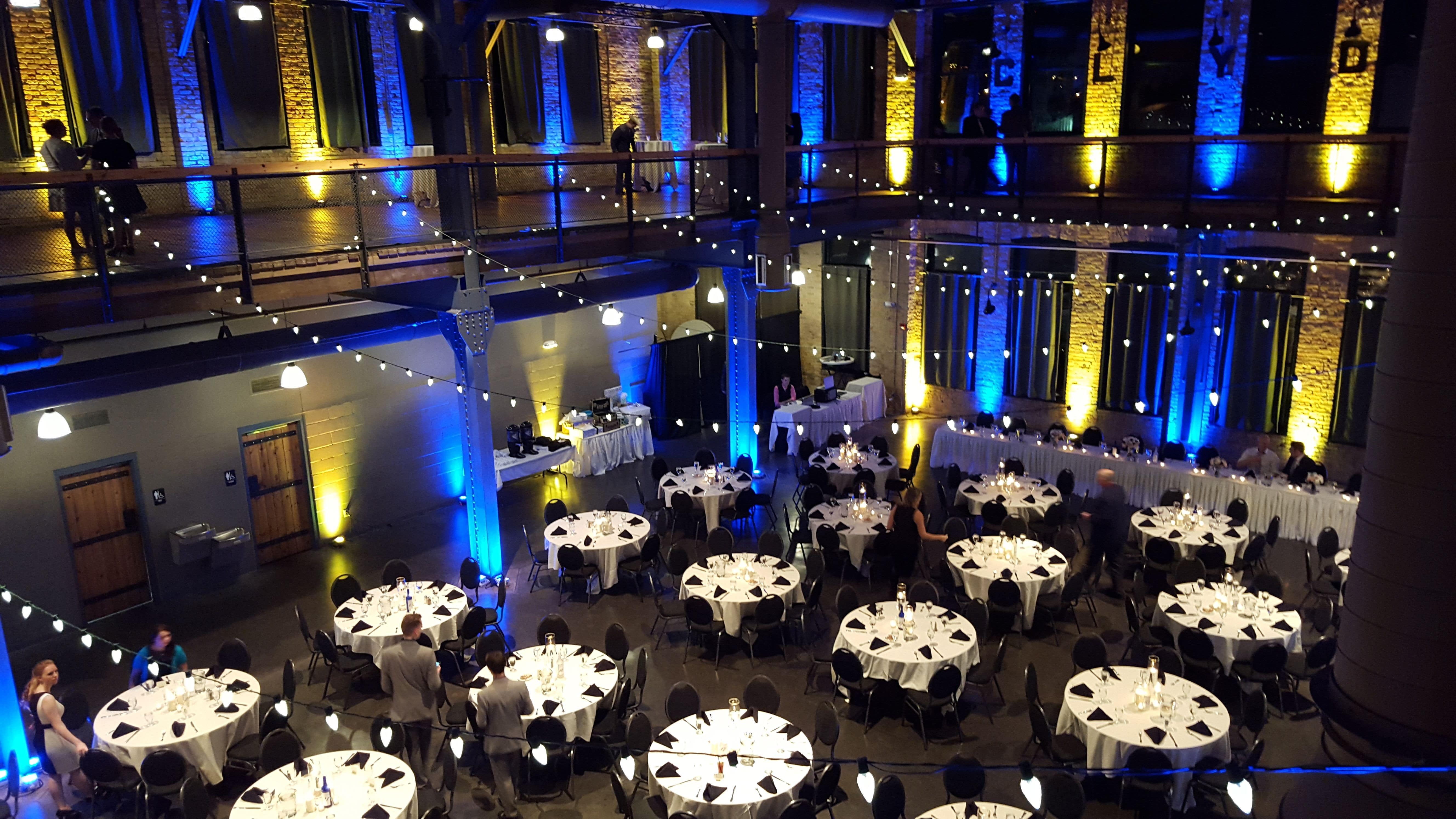 Wedding lighting at Clyde Iron Works with both levels lit in blue and yellow.