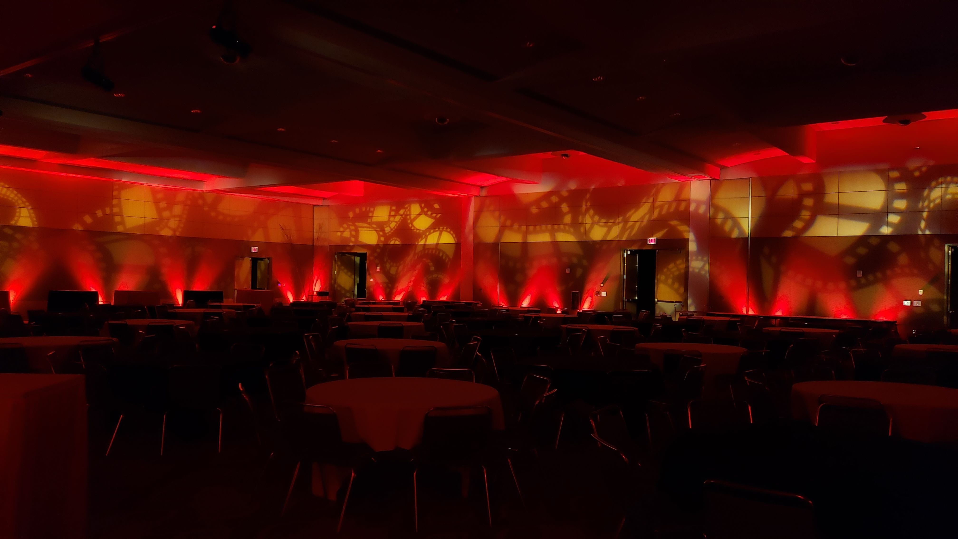 DECC, Harbor Side Ballroom.
Angled red up lighting with movie reel gobos on the walls.