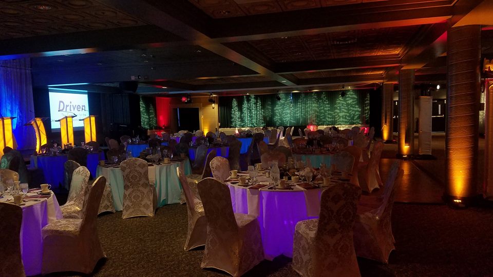 Up lighting in a dim red and a gold for school colors. Decor by Northland Special Events.