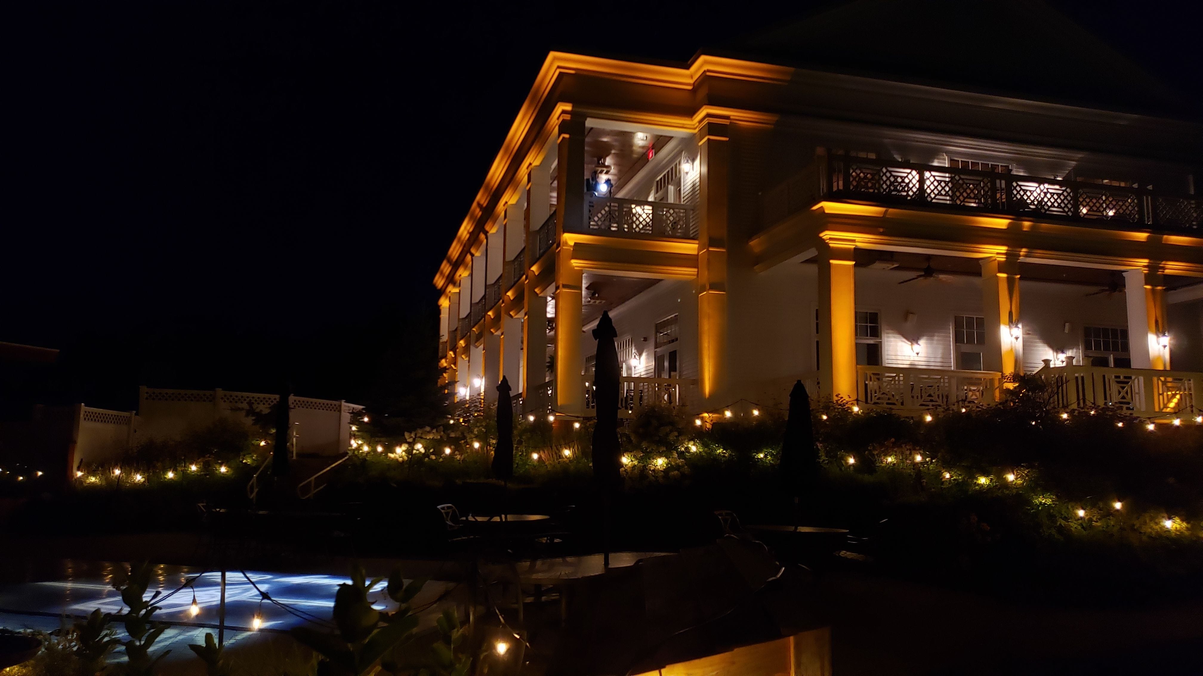 The Northland Country Club lit in amber with garden bistro.