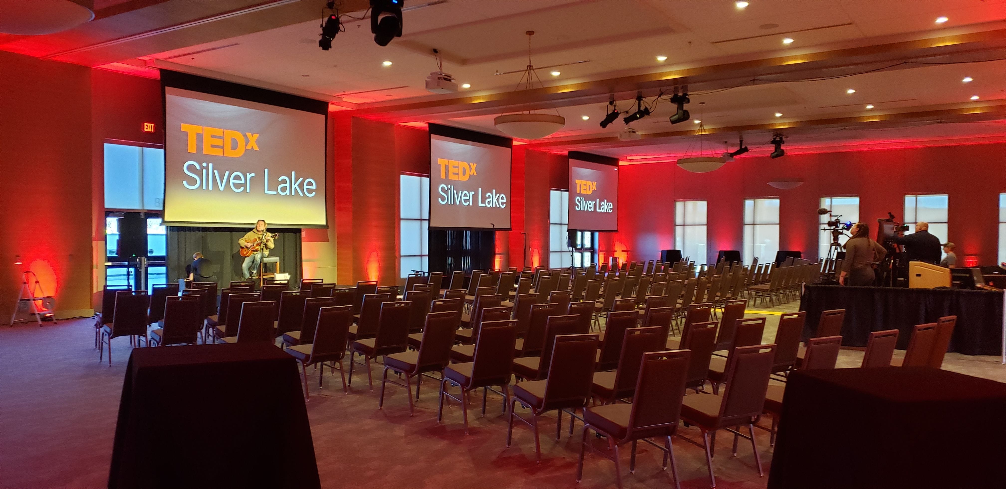 Stage lighting and red room up lighting for a ted talk.