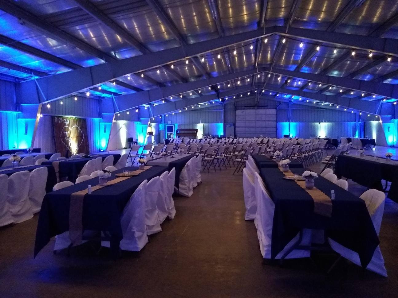 Lake County Fairgrounds wedding lighting in blue and white with bistro on the beams by Duluth Event Lighting.