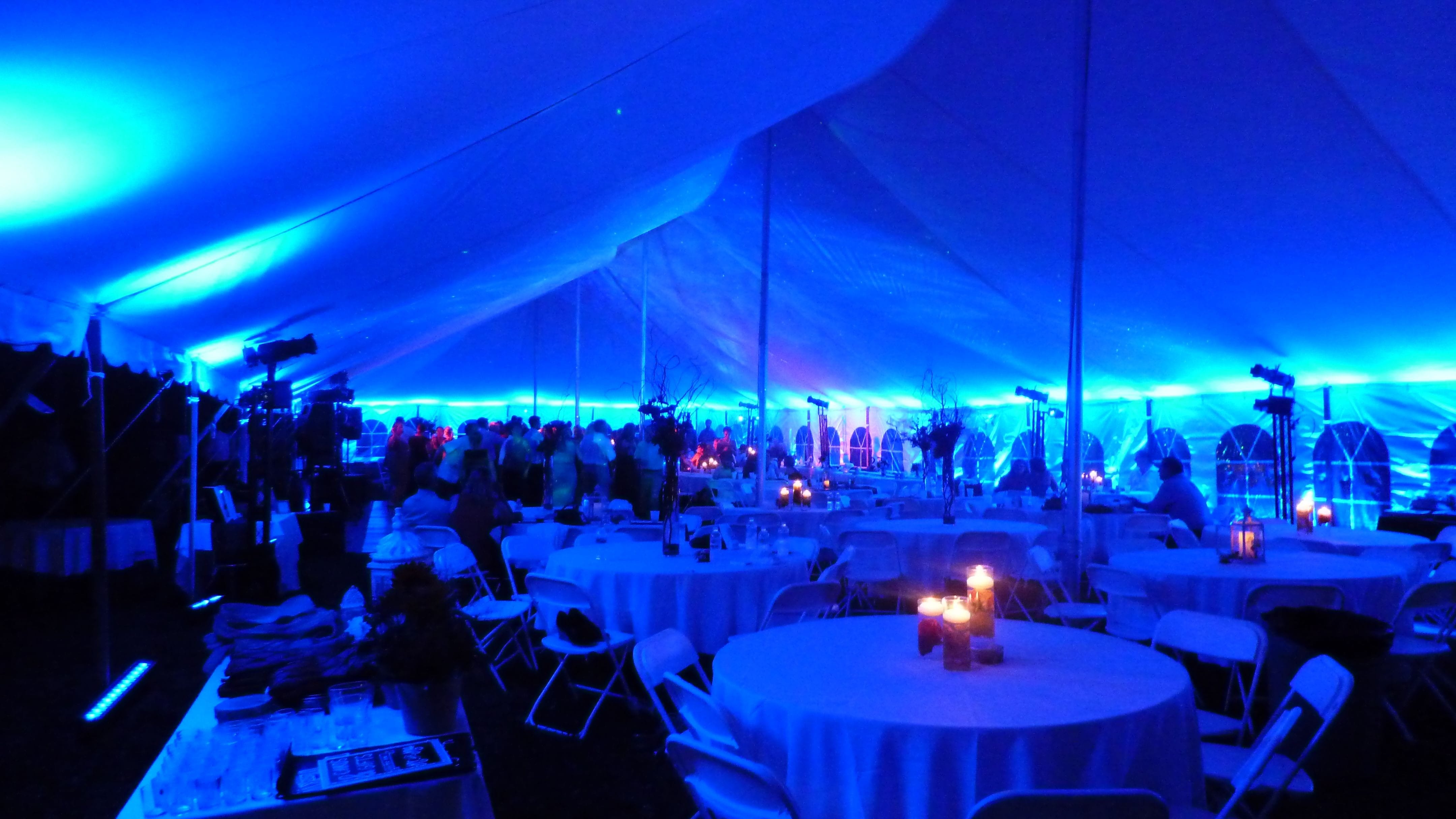 Tent wedding lighting. Up lighting in blue, Stars and Northern Lights on the ceiling.