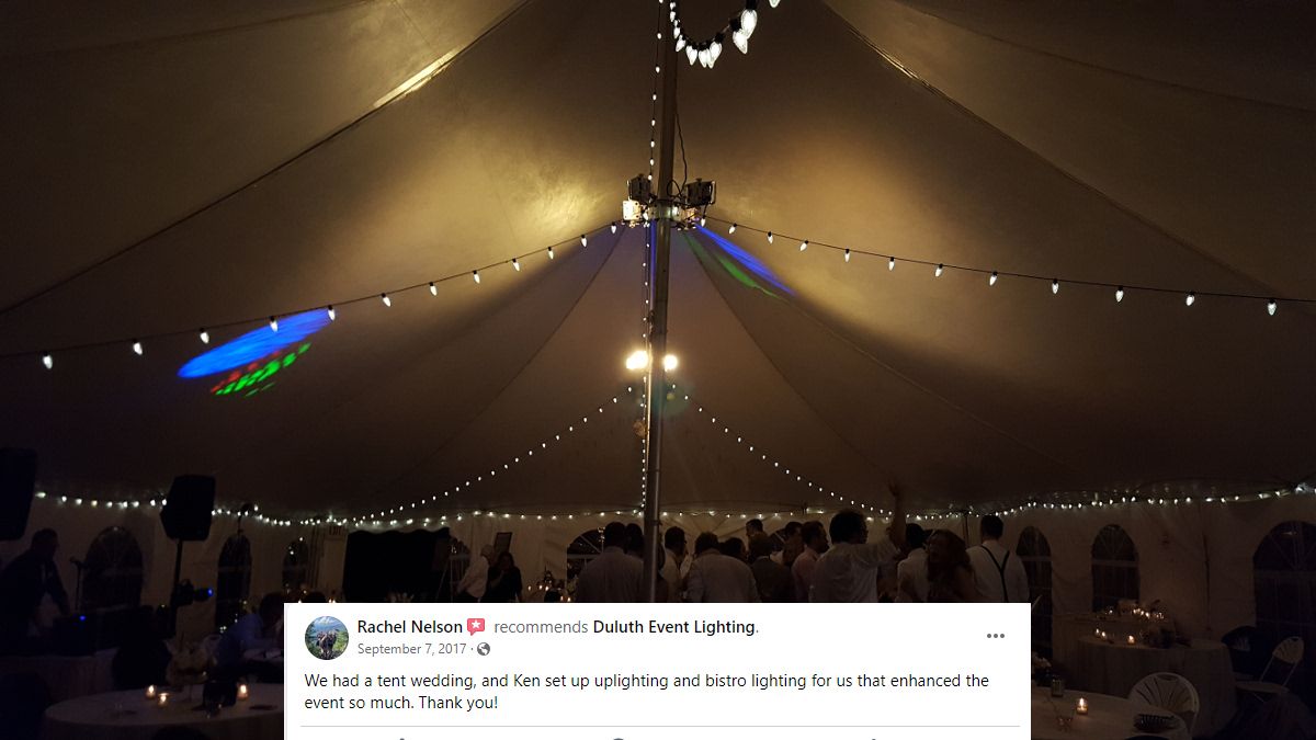 Wedding lighting in a tent with soft gold up lighting and bistro