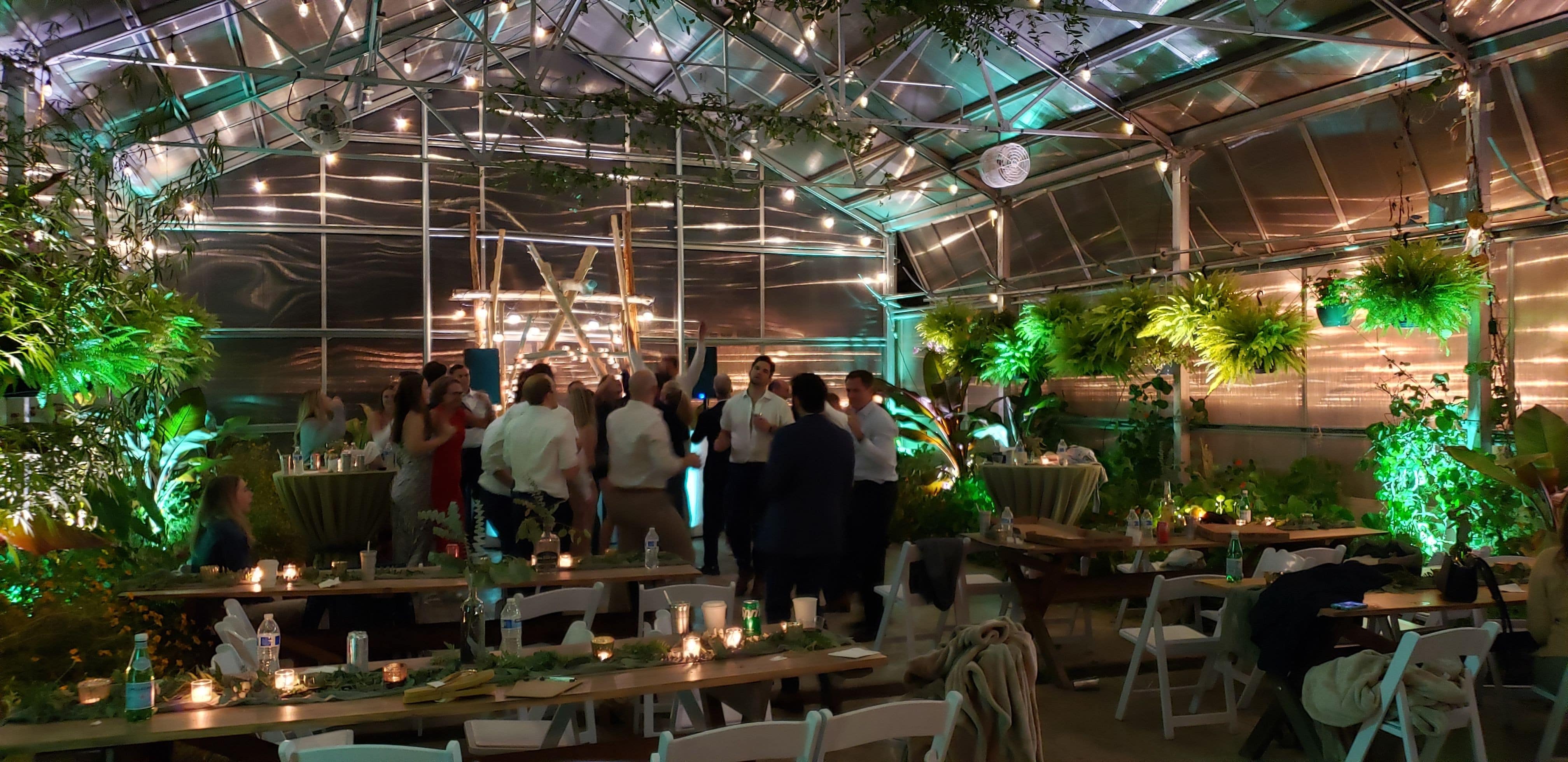 Mint Green up lighting for a wedding inside the greenhouse of Sitio Events.