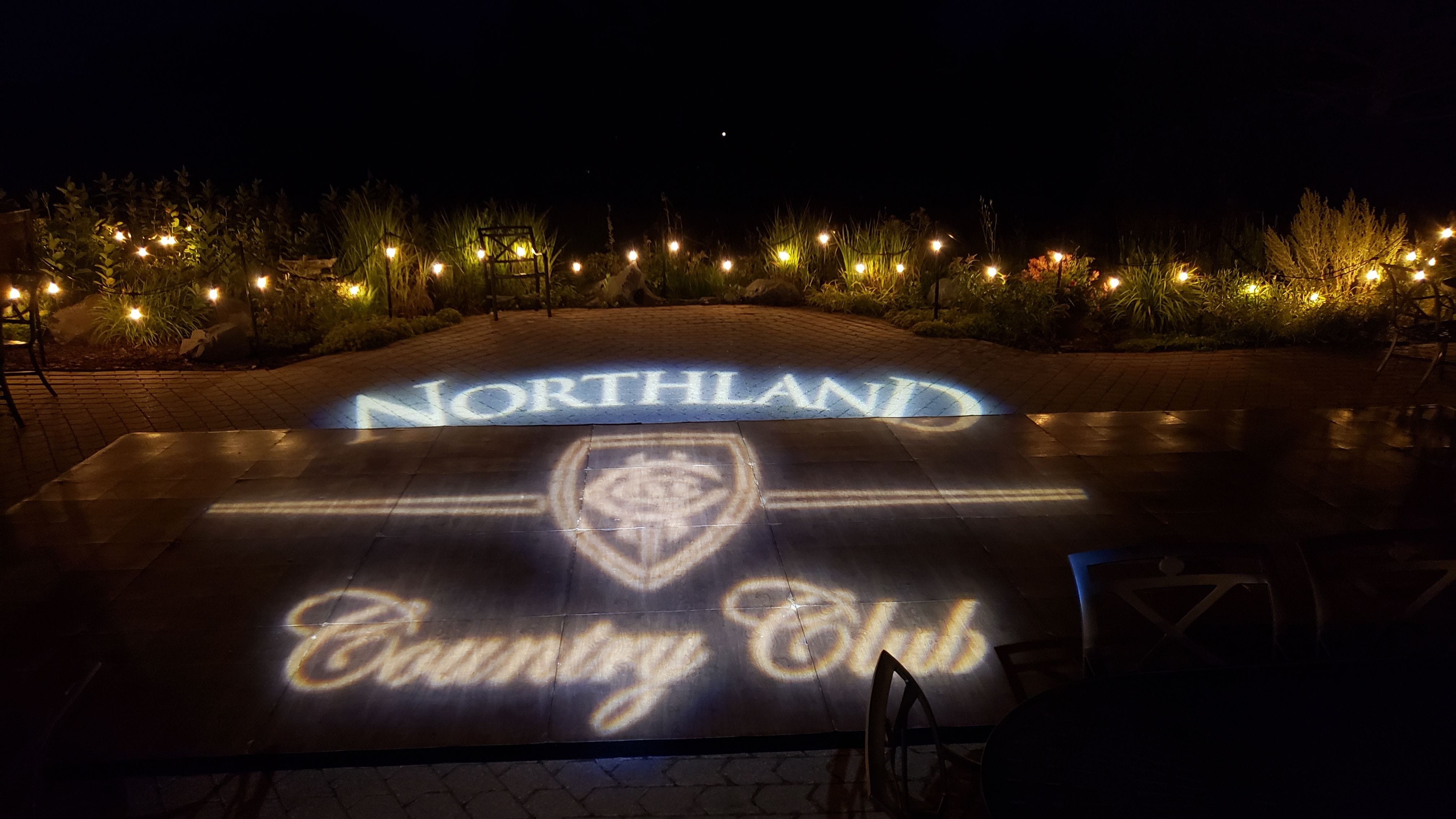 Wedding lighting at the Northland Country Club. Garden bistro and the club logo on the dance floor.