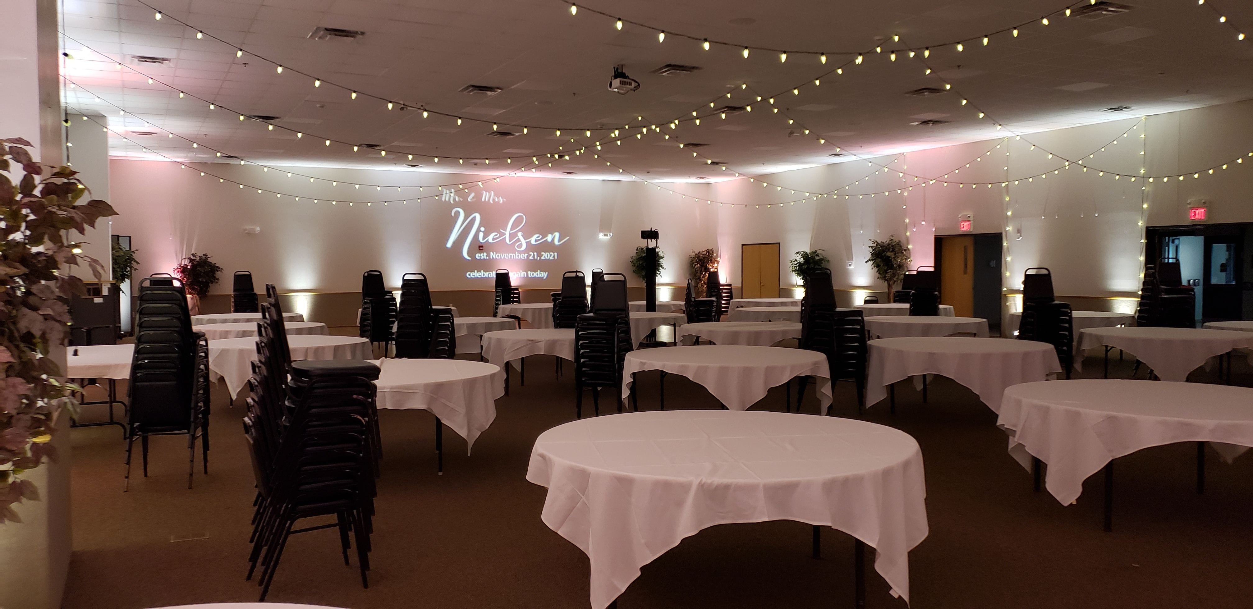 Wedding lighting at the AAD Shrine with blush pink and white up lighting with a wedding monogram and bistro on the ceiling.