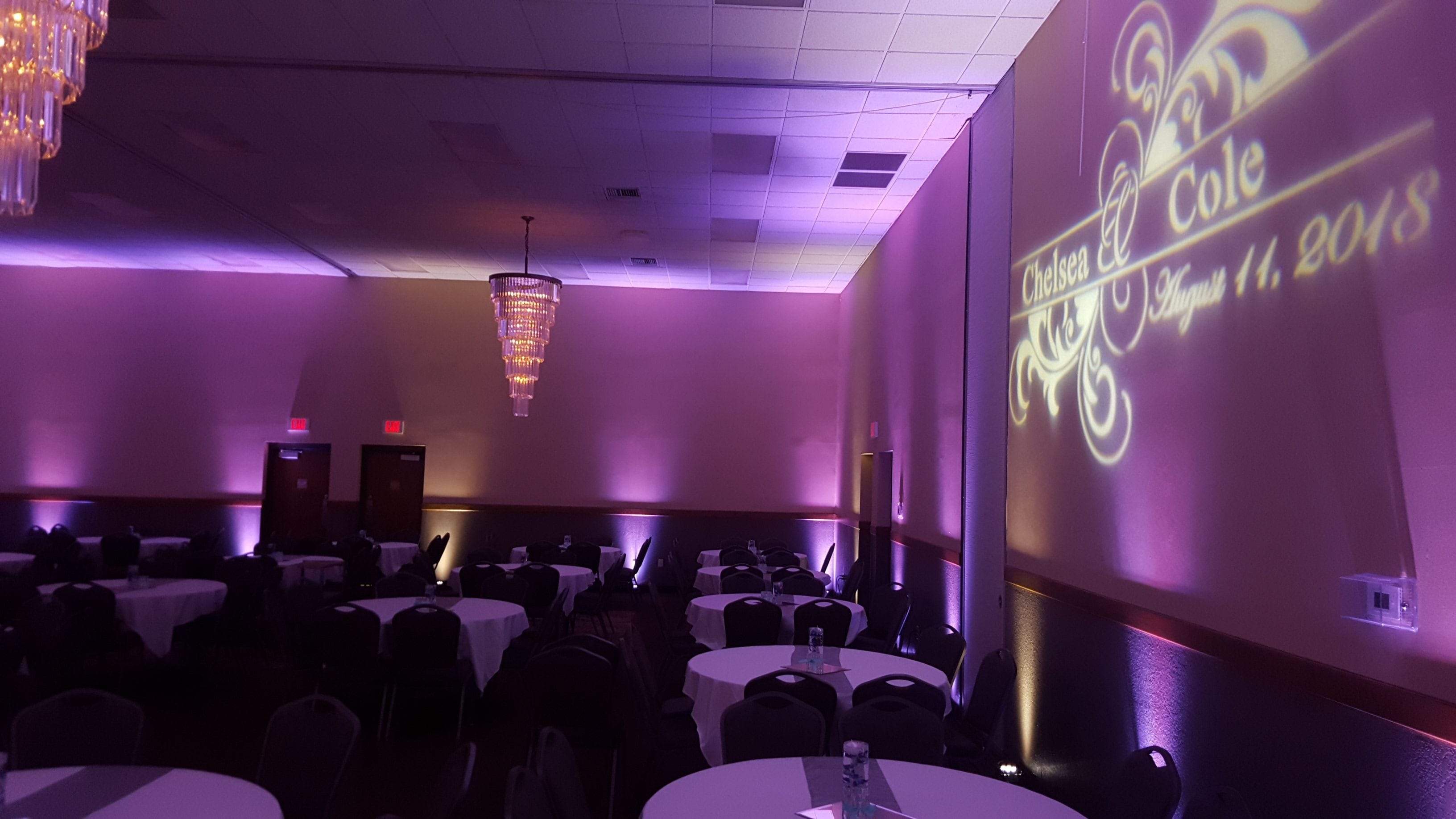 Wedding lighting at Barker's Island. Up lighting in lavender and soft white with a wedding monogram.