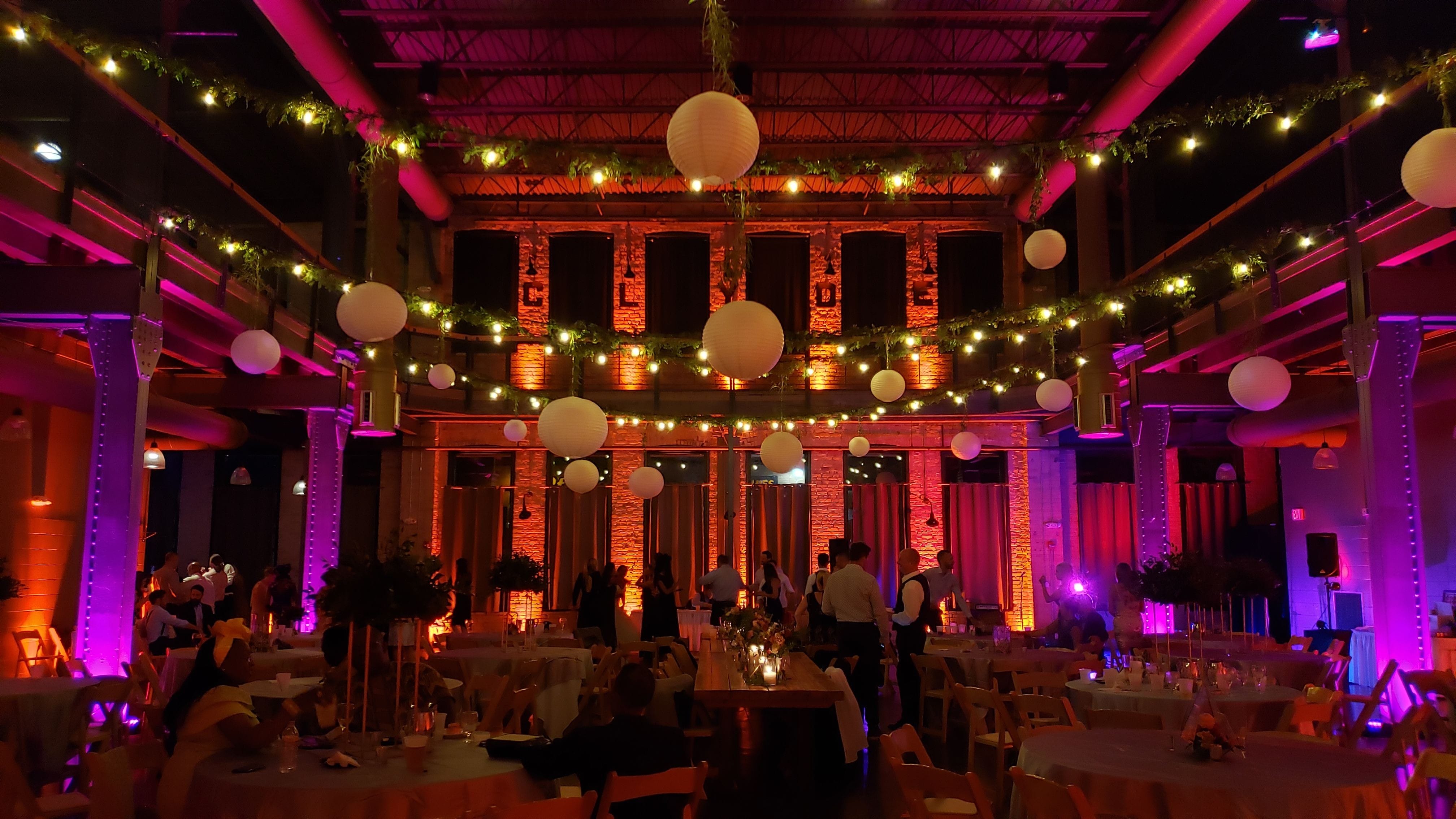 Wedding lighting at Clyde. Up lighting in orange and hot pink. NSE greenery on our bistro.