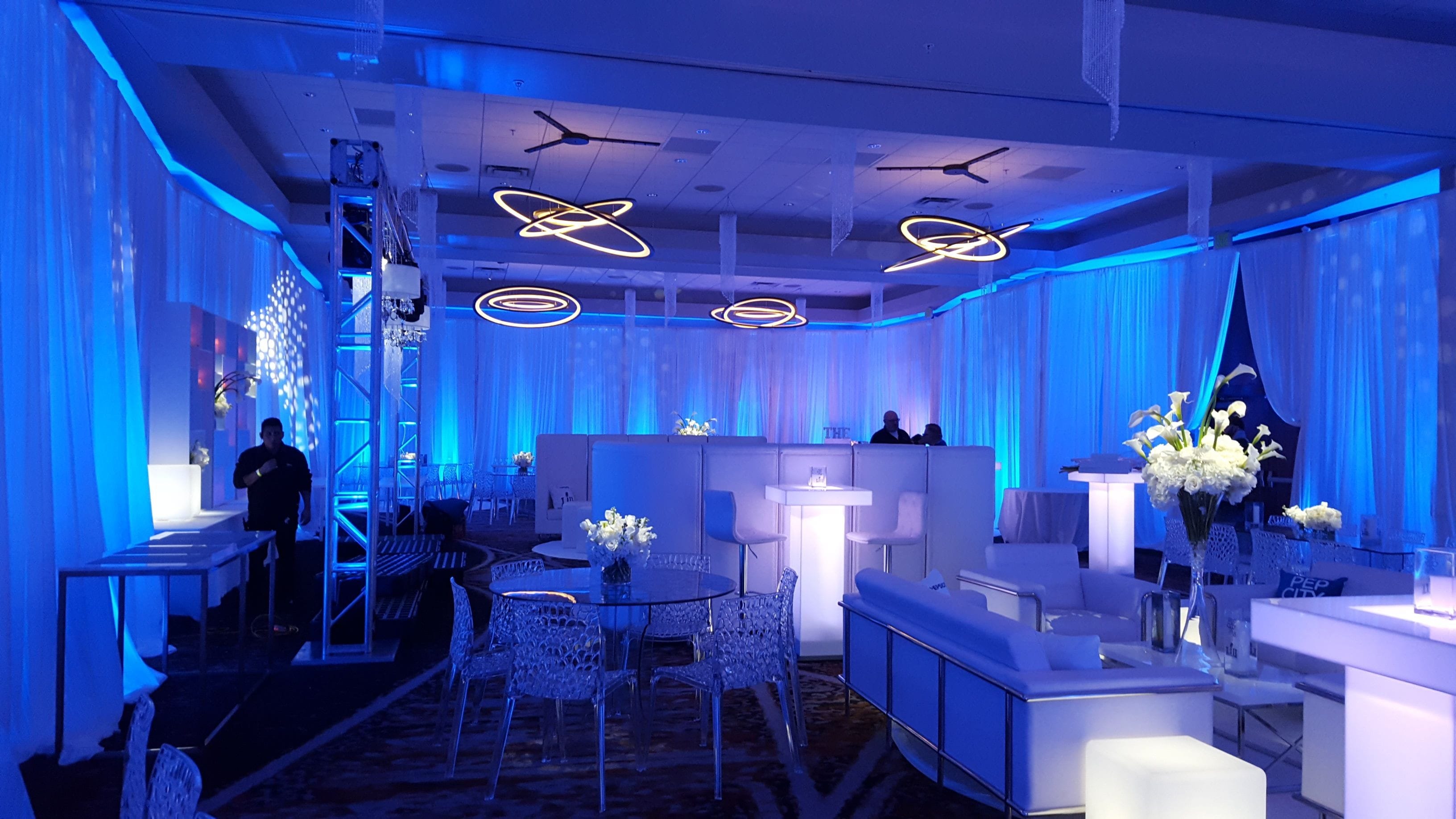 Blue up lighting with glowing cocktail tables, pin spots and gobos for a pre Super Bowl party at the Minneapolis Renaissance Depot Hotel.