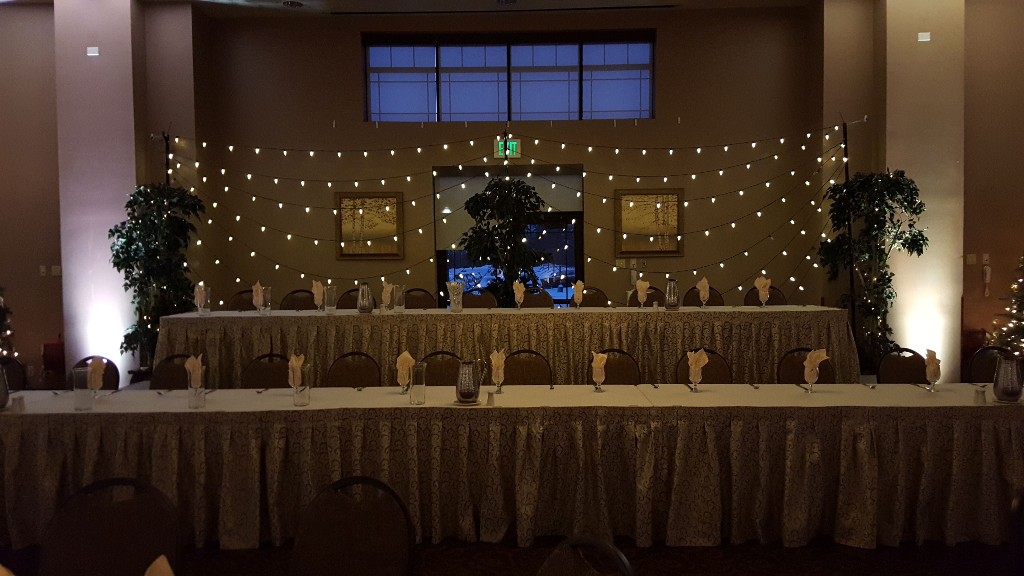 wedding lighting with bistro and Christmas Lights as a head table backdrop. Duluth Event Lighting.
