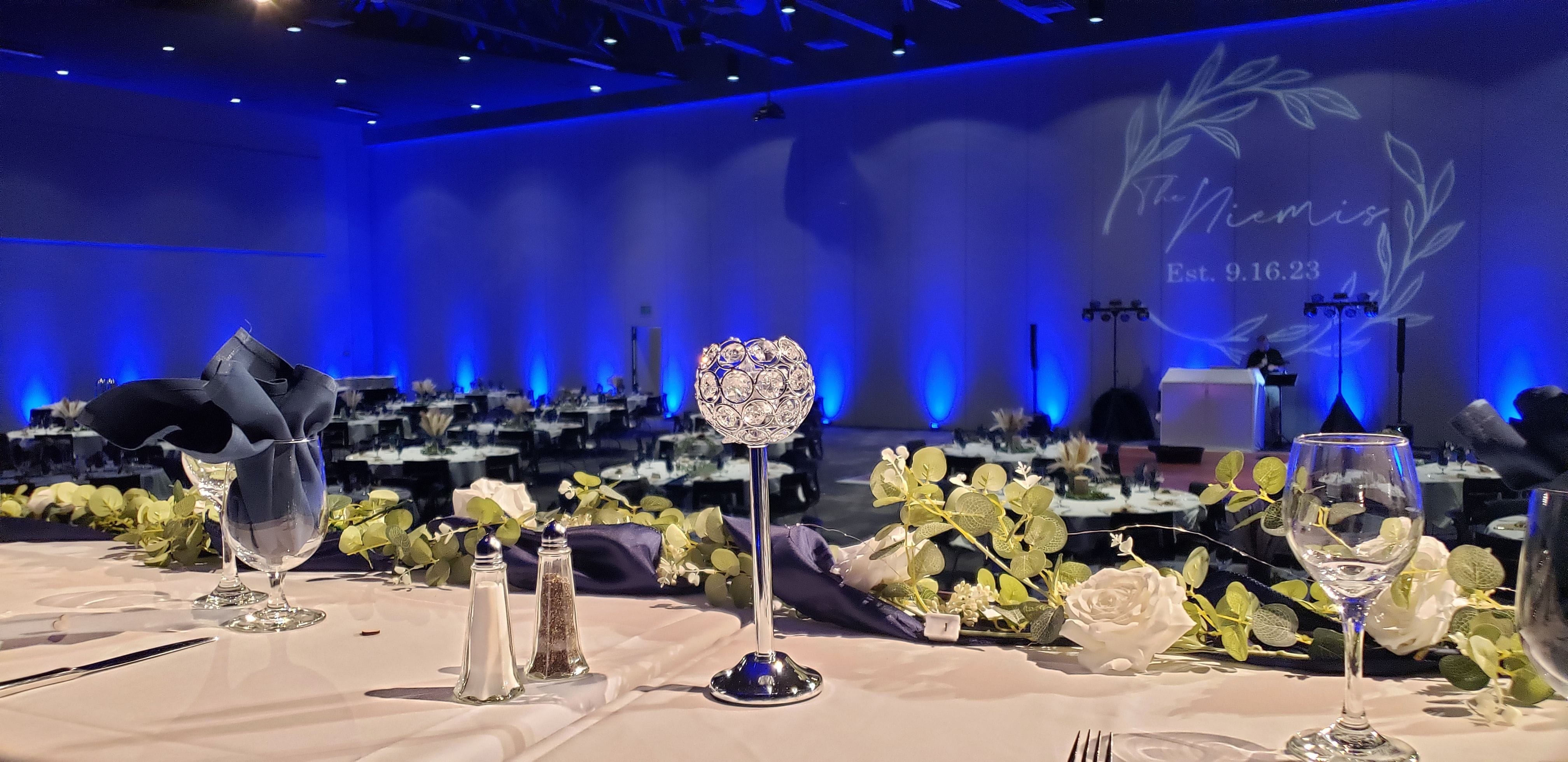 A wedding in the Otter Creek Convention Center at Black Bear Casino with blue up lighting by Duluth Event Lighting