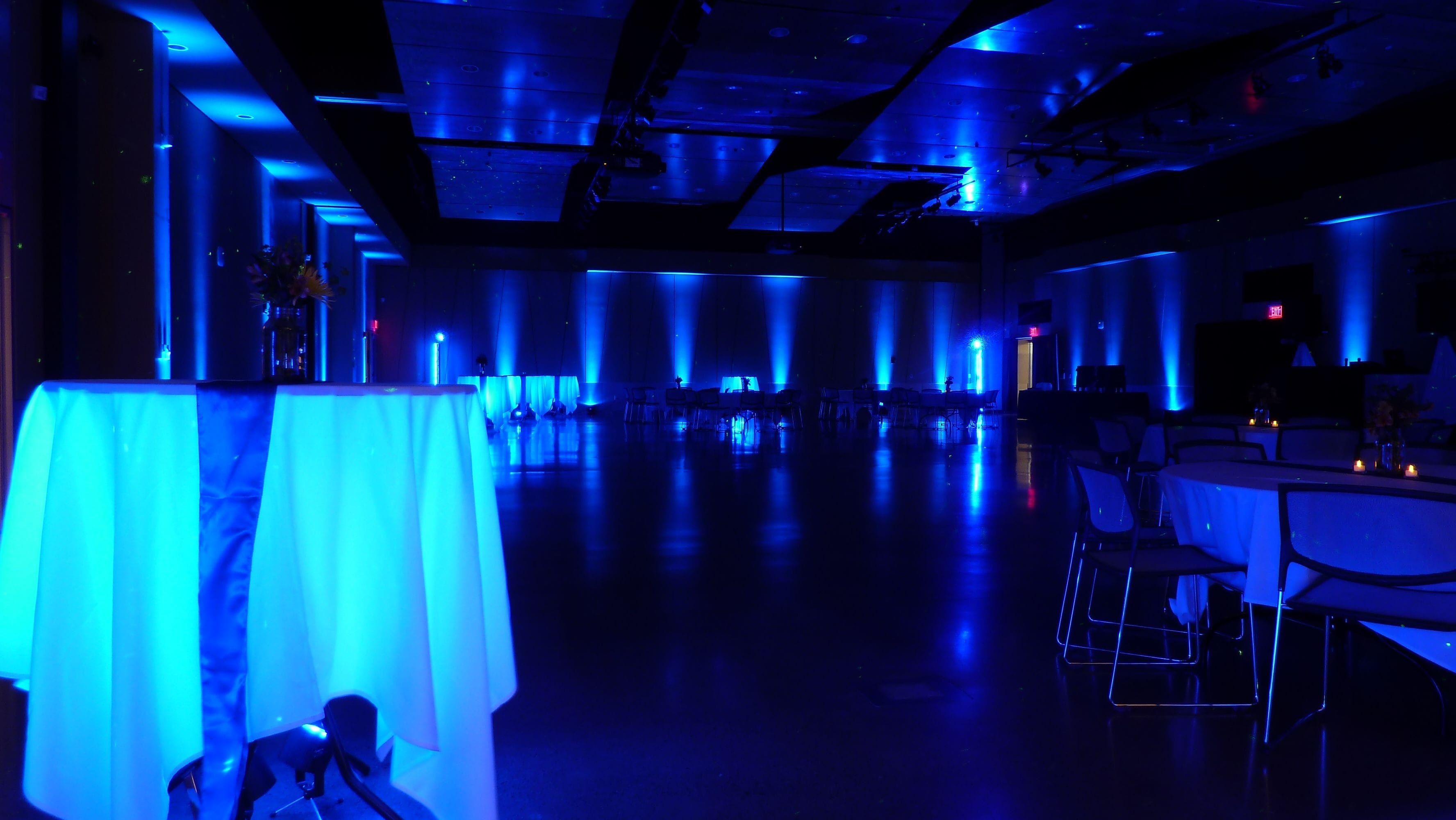 Wedding lighting at UWS, Yellowjacket Union. Up lighting in blue with glowing cocktail tables.