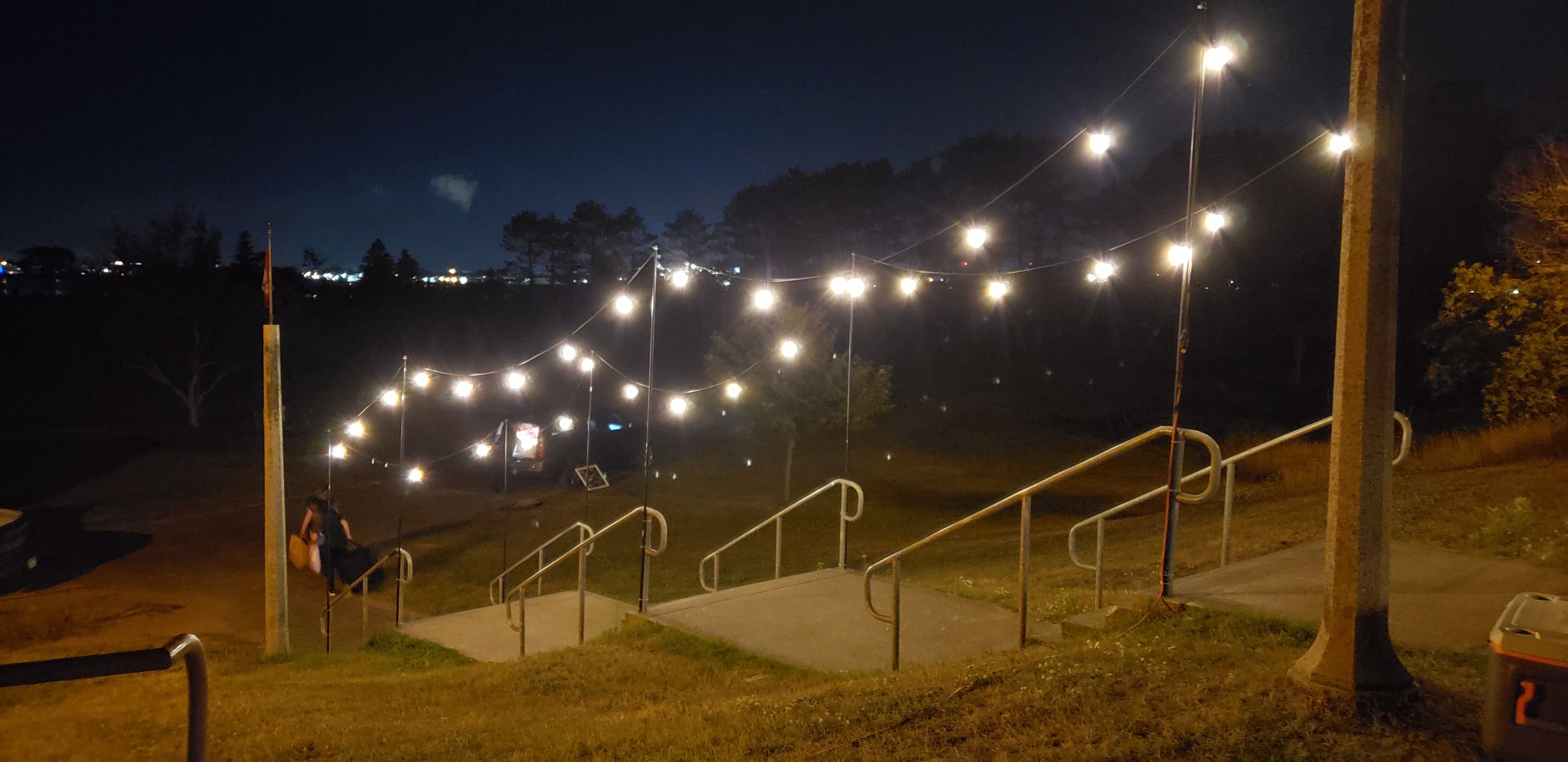 Wedding lighting with bistro over the front steps at the Park Point Beach House.
