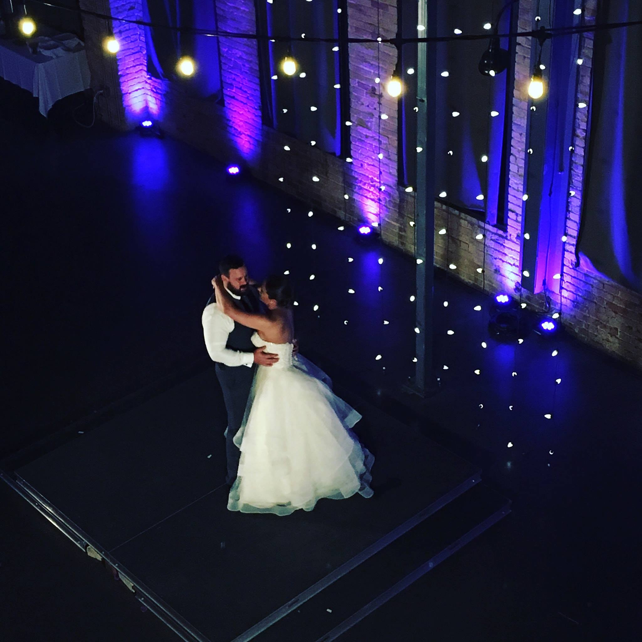 A Clyde wedding with bistro over the balcony as a backdrop by Duluth Event Lighting.