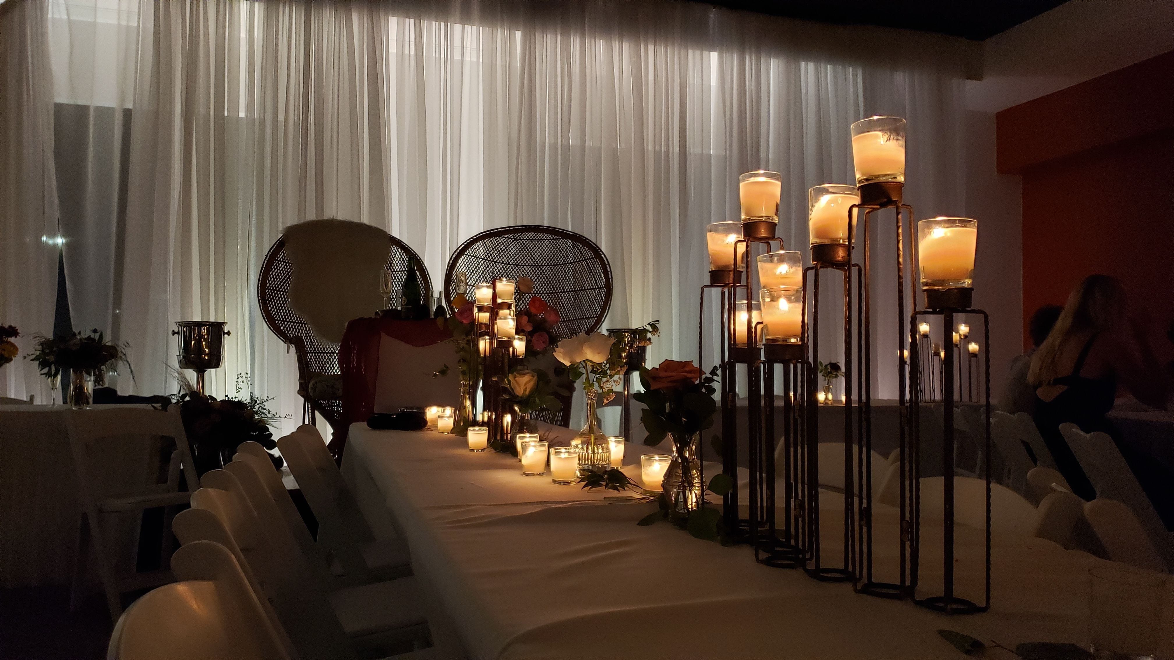 Pipe and drape lighting behind a sweetheart table for a wedding at Pier B.