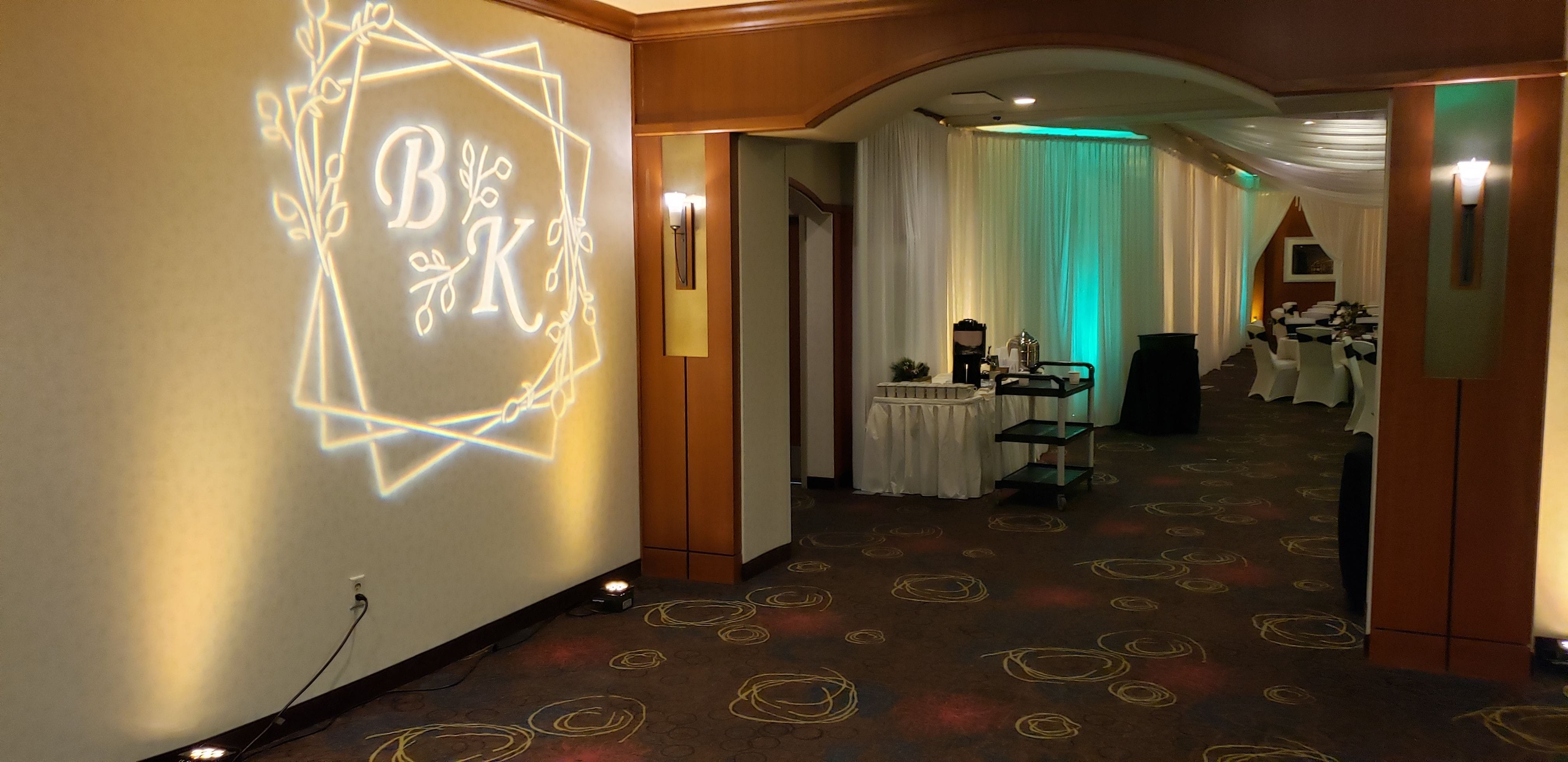 wedding lighting at the Holiday Inn, in the Great Lakes Ballroom. Up lighting in mint green and soft gold with a wedding monogram by Duluth Event Lighting.