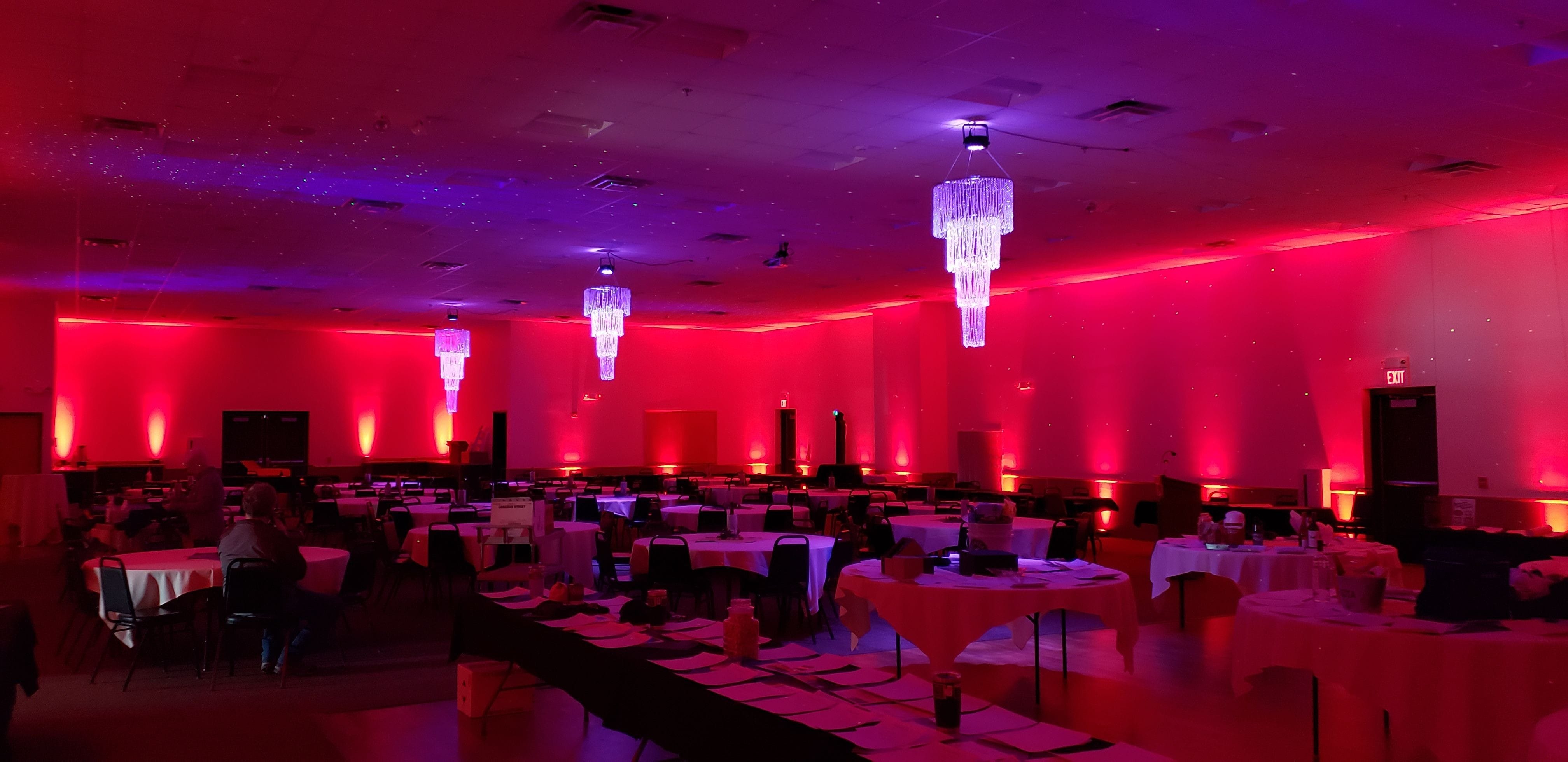 Wedding lighting at the AAD Shrine by Duluth Event lighting with 3 chandeliers and red up lighting