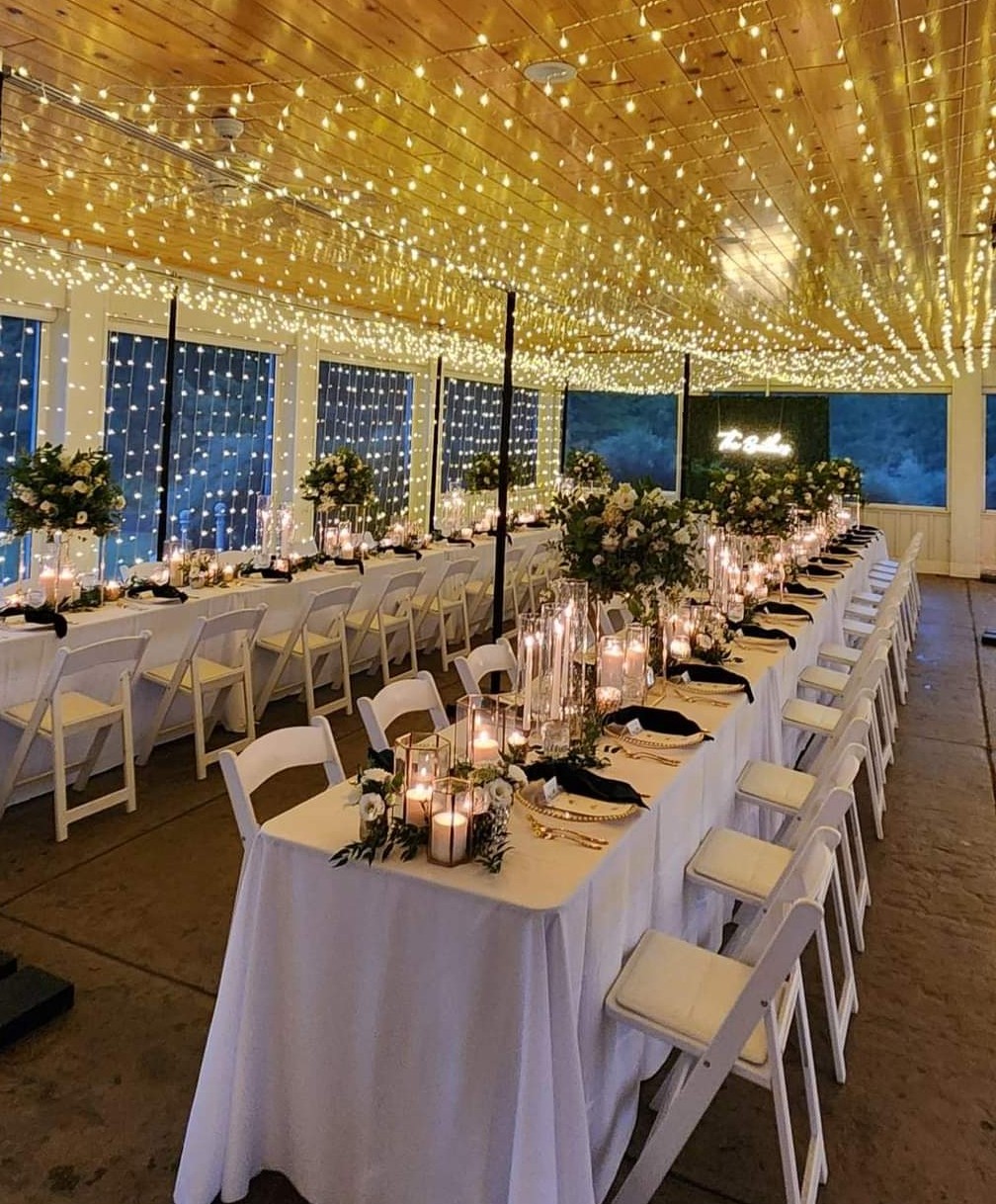 A ceiling full of lights with a LED curtain canopy over wedding tables.