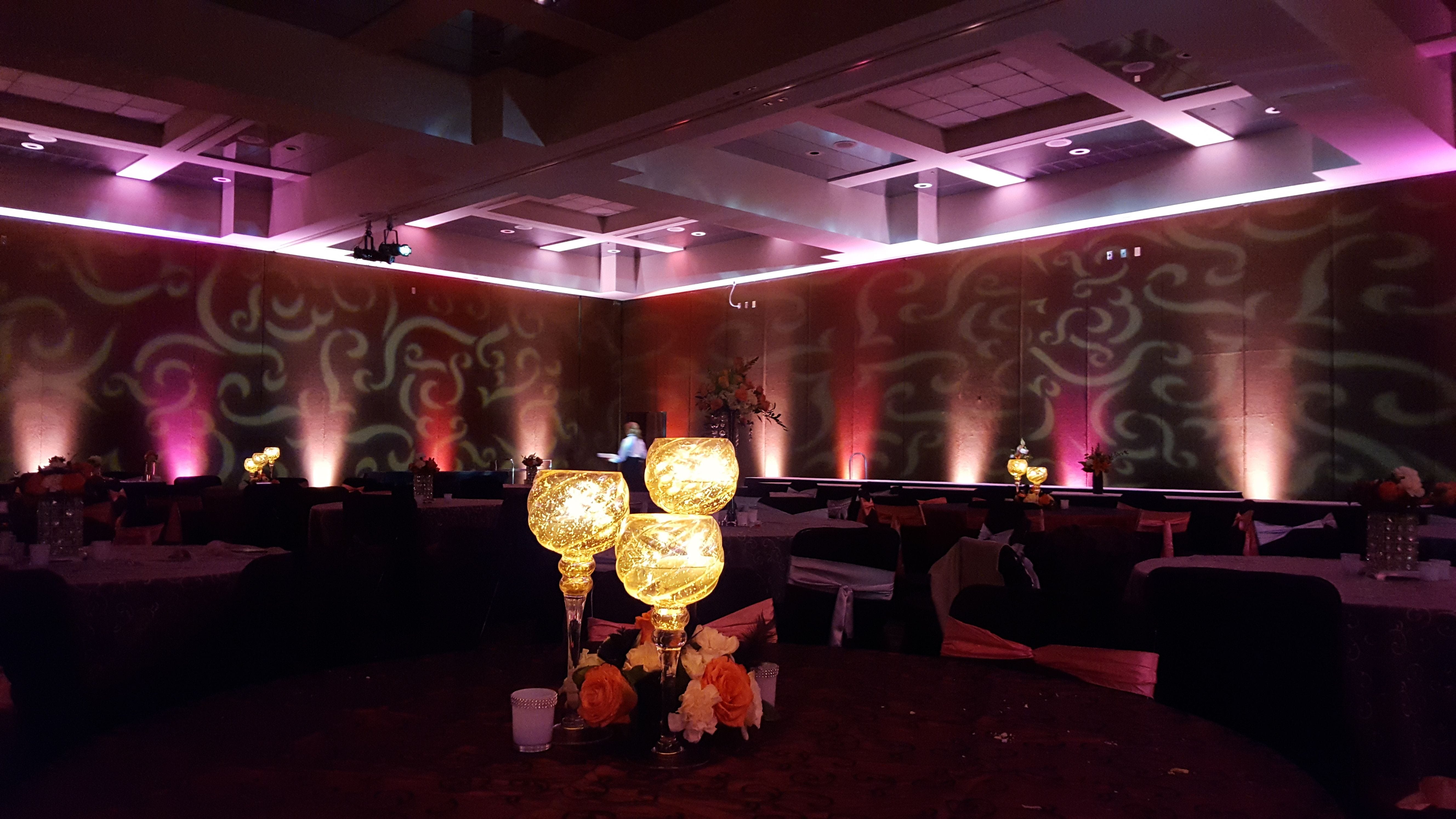 Fancy wedding lighting at the DECC. Up lighting in 2 tone pink and red with fancy patterns on the walls.