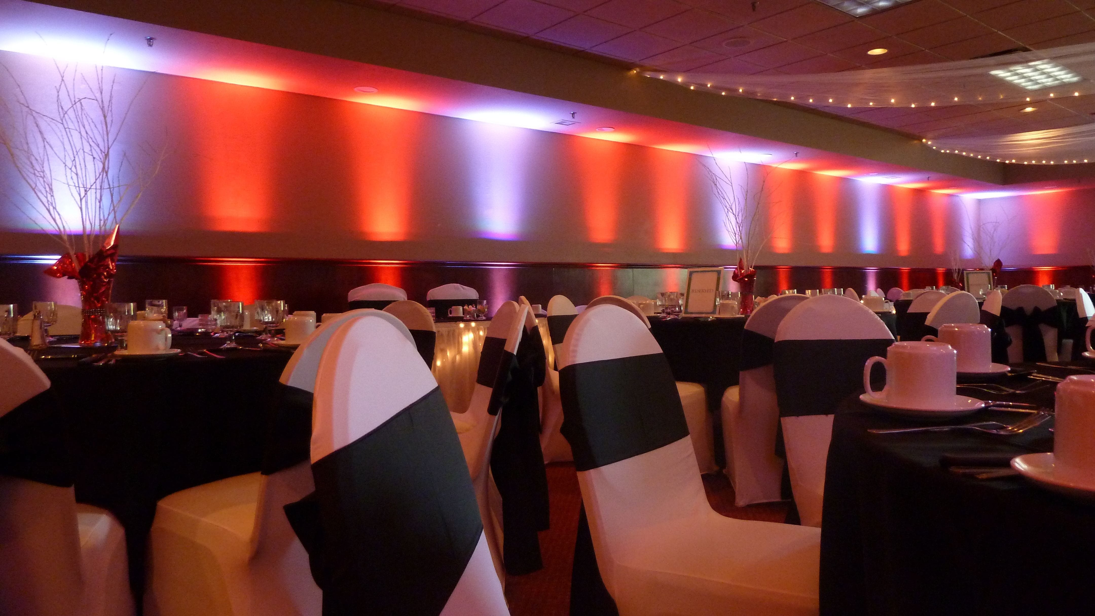 Wedding lighting at Blackwoods Event Center in Proctor. Up lighting in a dim red and cool white.