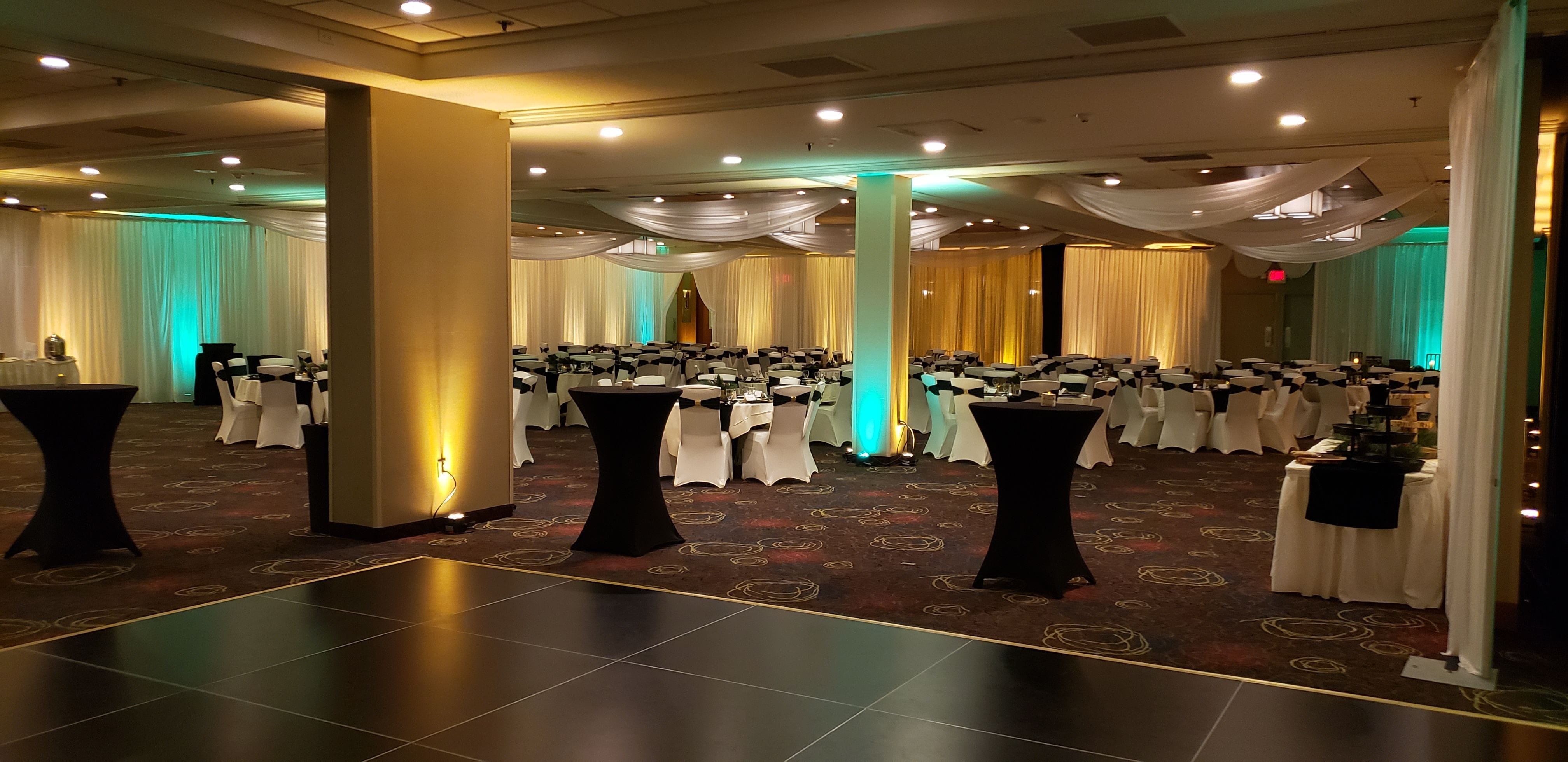 wedding lighting at the Holiday Inn, in the Great Lakes Ballroom. Up lighting in mint green and soft gold with a wedding monogram by Duluth Event Lighting.