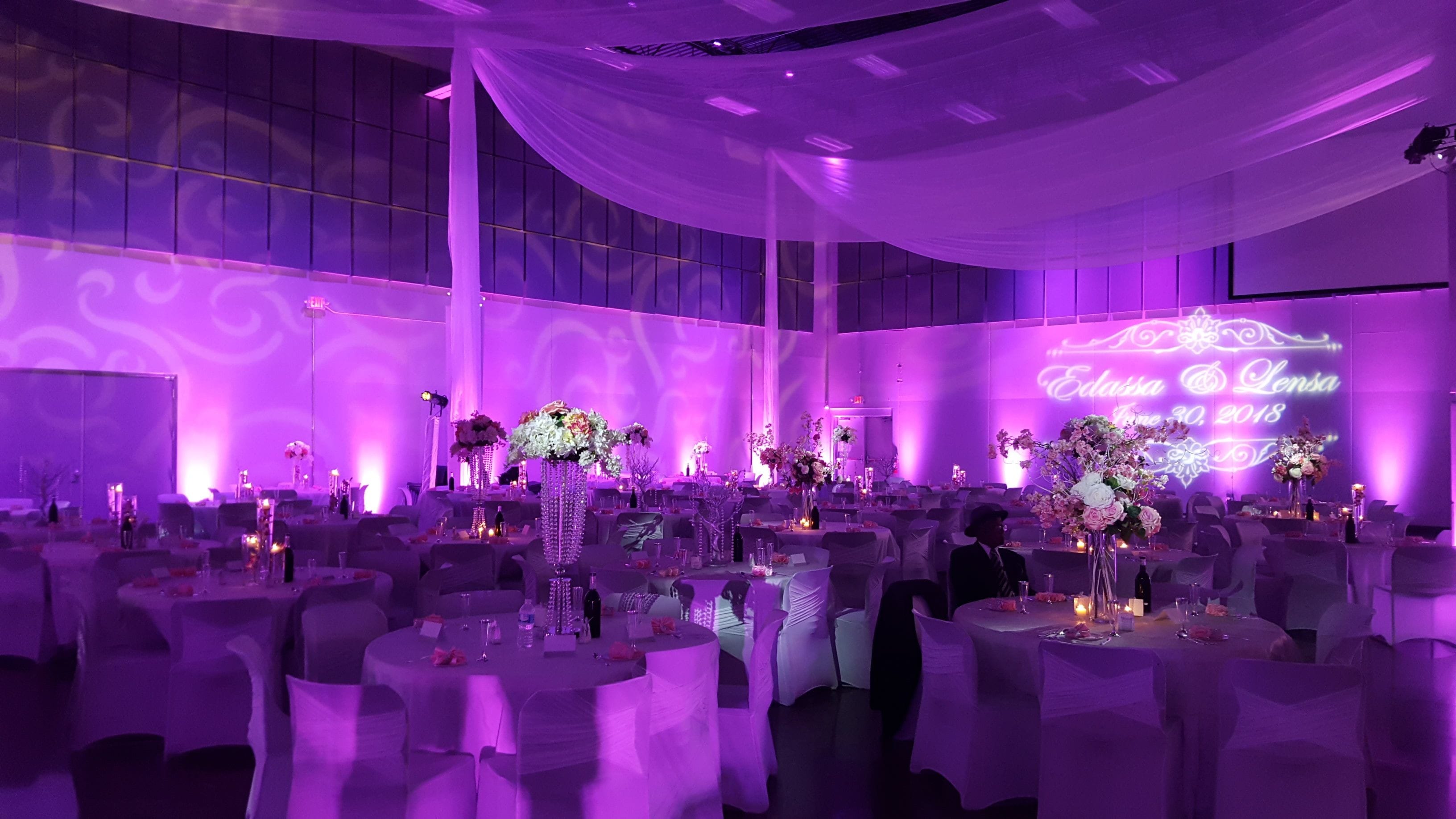 Passion Event Center, Fridley.
Wedding lighting in Magenta pink. Pin spots on flowers, wedding monogram, gobo patterns on walls.