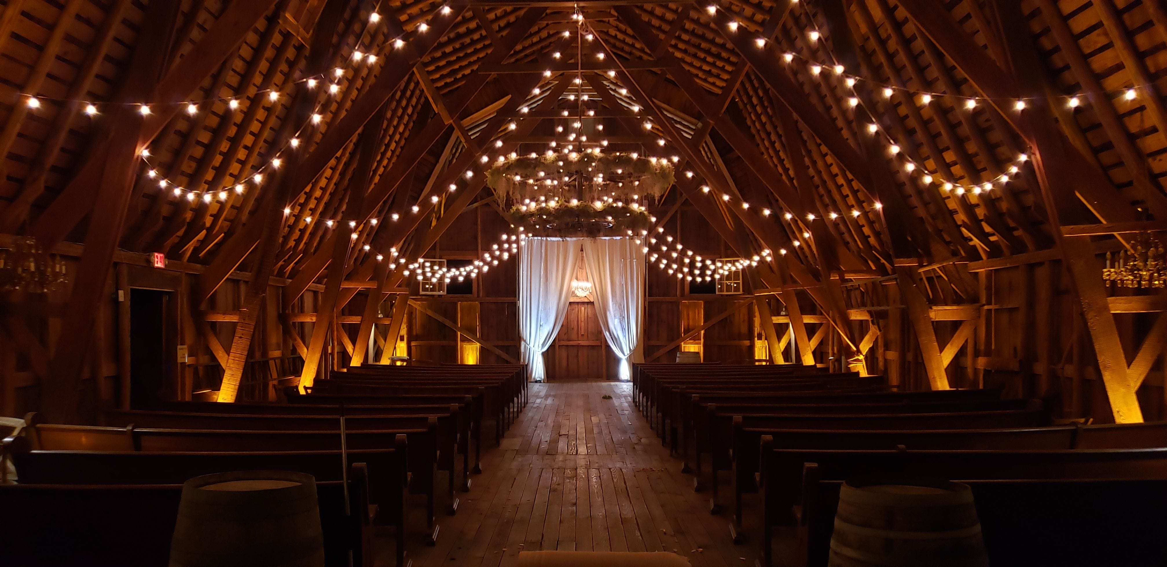 The Grainary's wedding barn with amber up lighting by Duluth Event Lighting for a wedding.