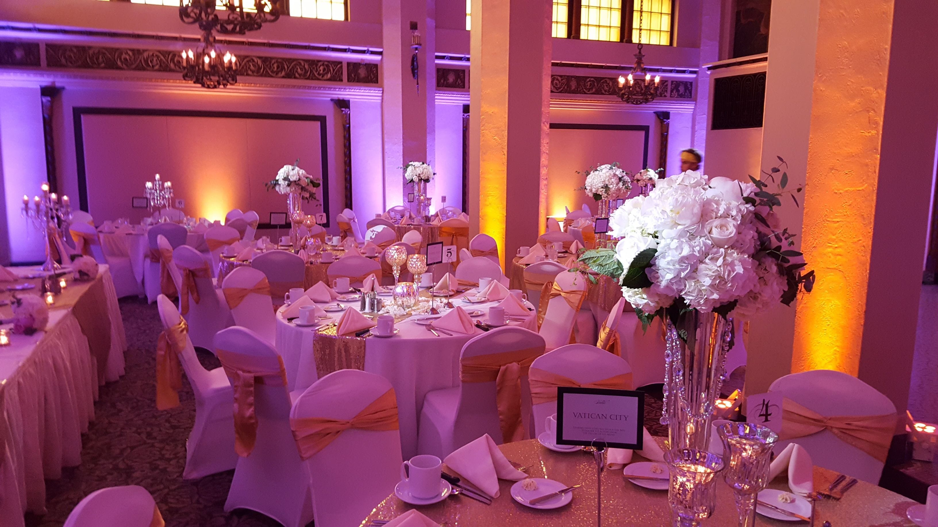 Moorish Room wedding.Up lighting in lavender and amber. Pin spots on flowers.