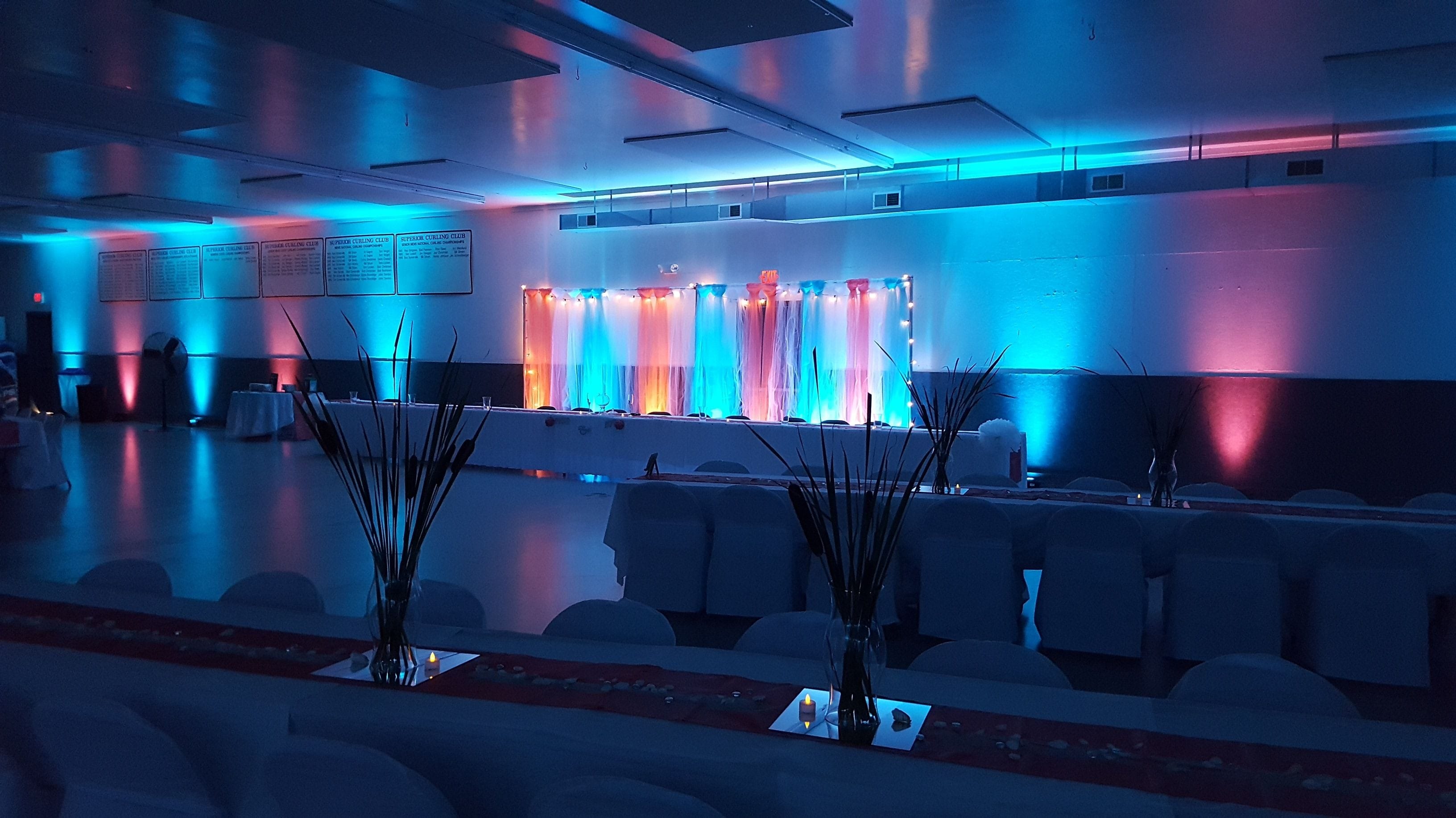 Wedding lighting in teal and coral at the Superior Curling Club.