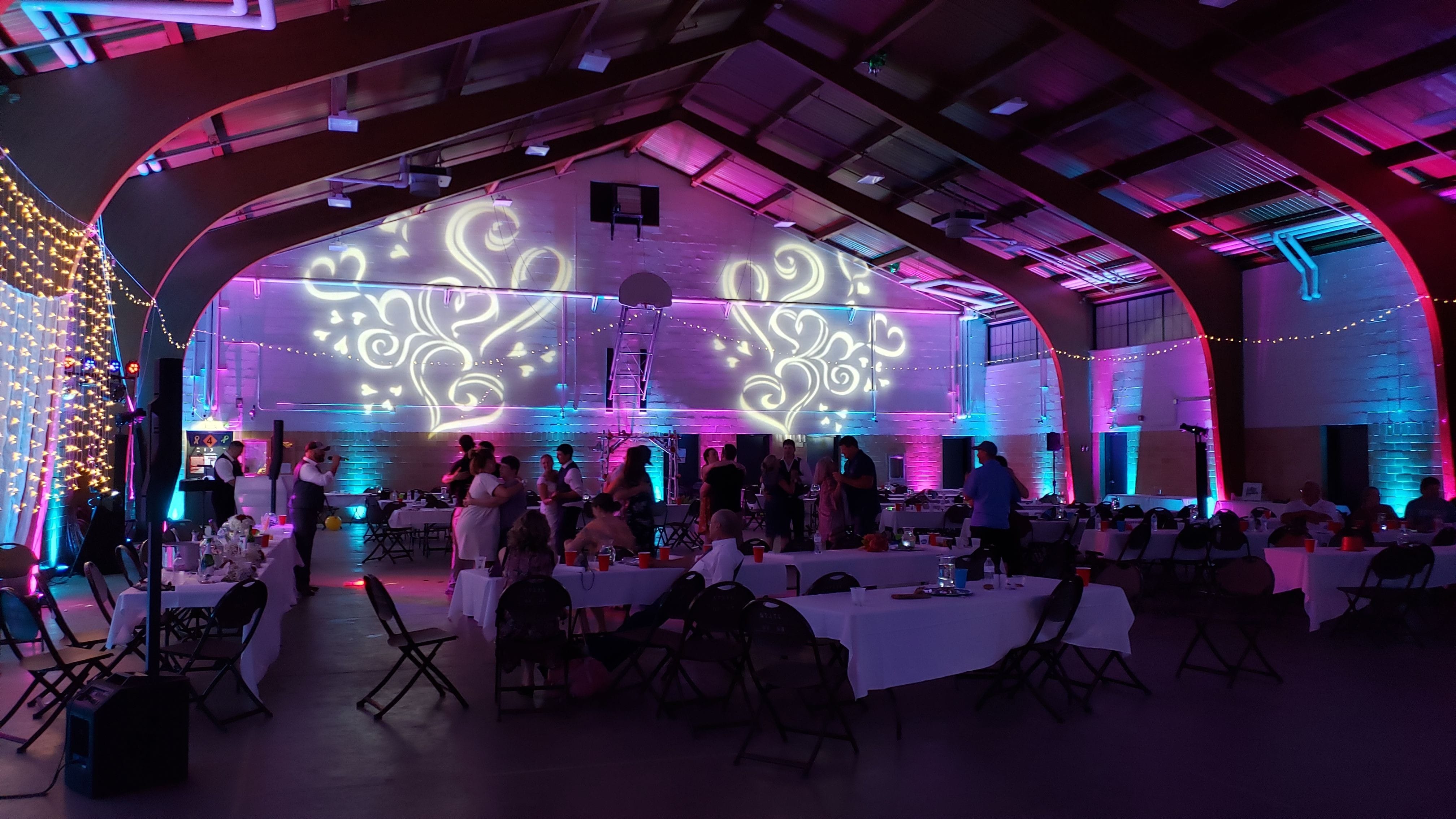 Wedding lighting at the Cloquet Armory with heart gobo patterns projected on the wall.