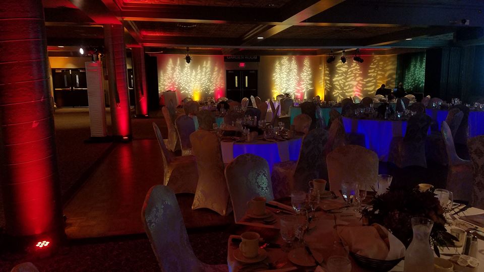 Up lighting in a dim red and gold for school colors at Kirby Ballroom. Decor by Northland Special Events.