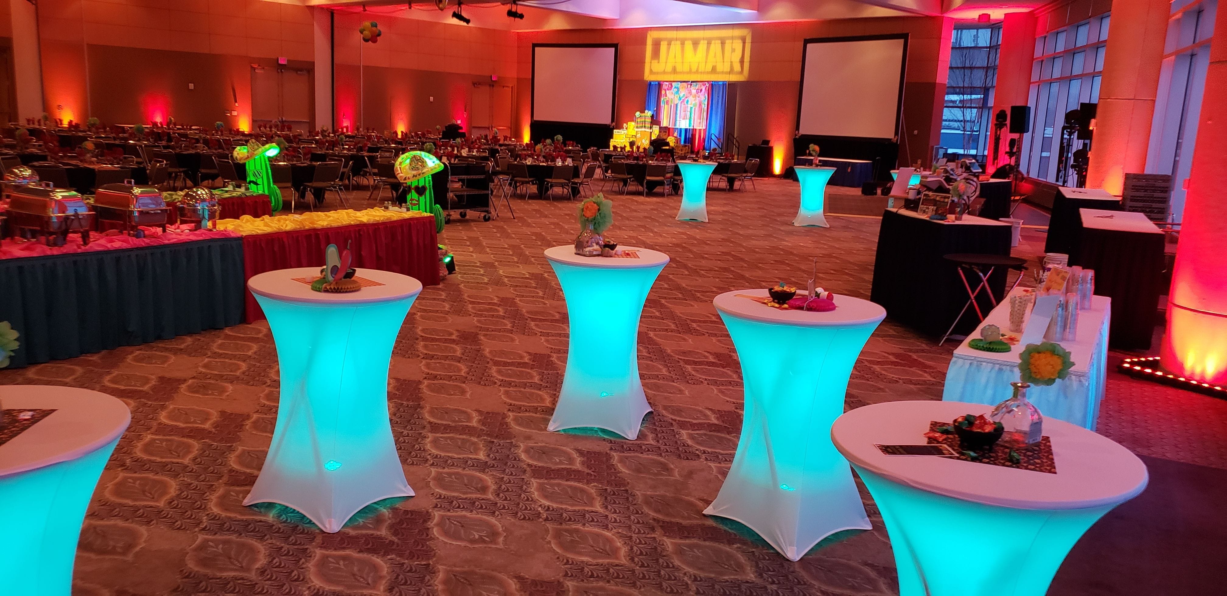 Teal battery lights under cocktail tables and red up lighting on the walls in the DECC Harbor Side Ballroom.