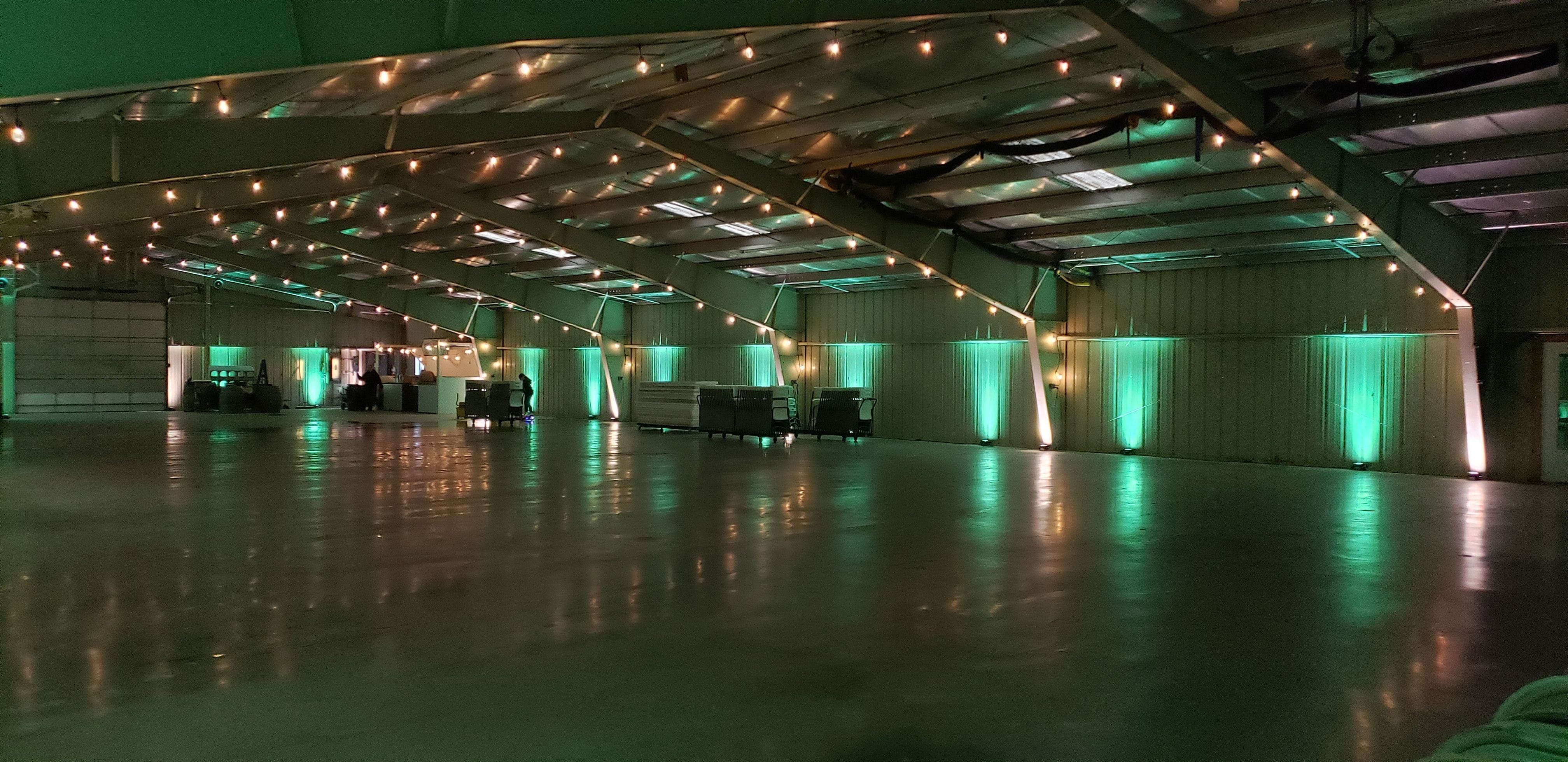 Wedding lighting at the Lakes County Fairgrounds. Up lighting in mint green and white with a head table backdrop by Duluth Event Lighting.