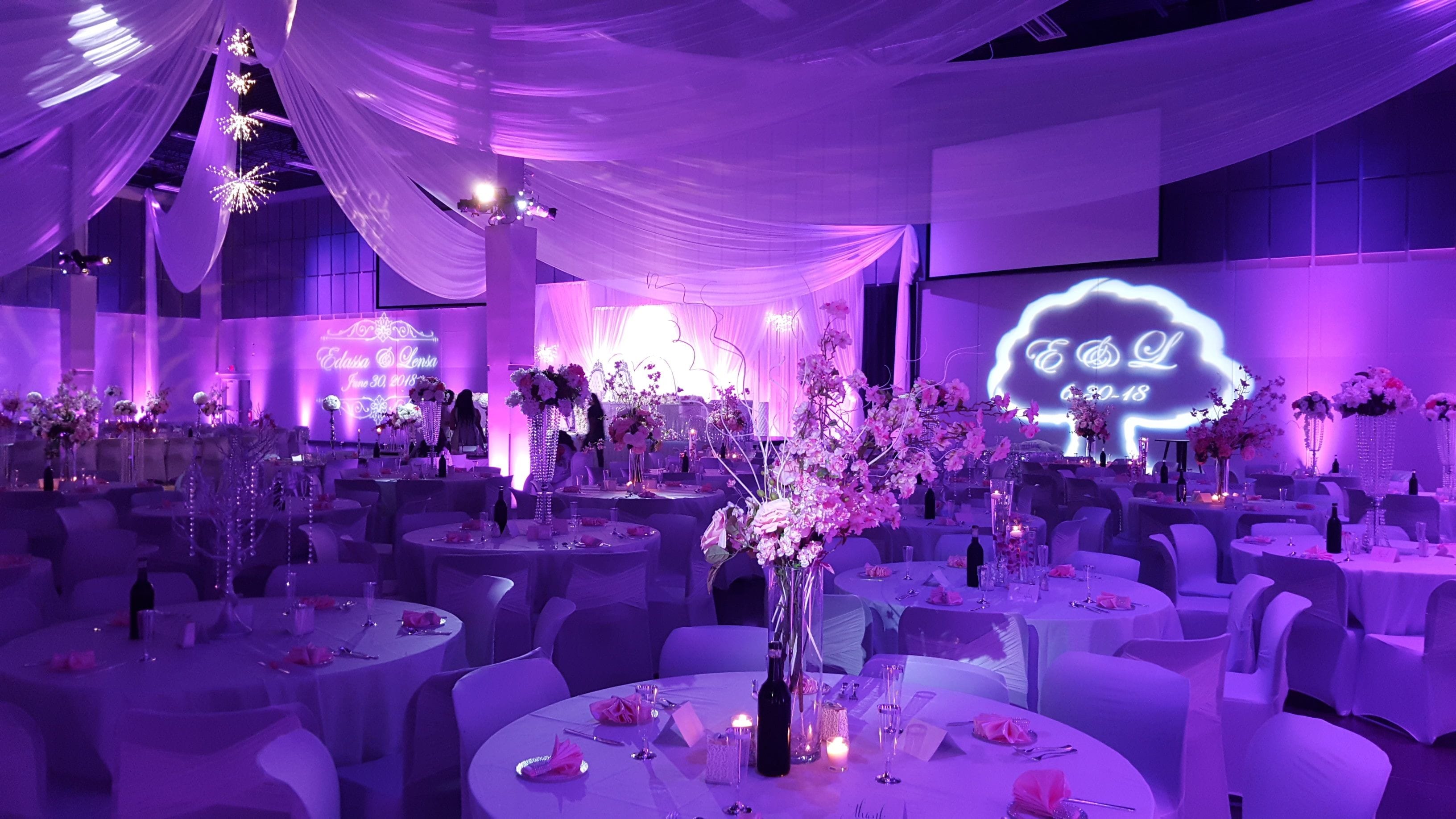 Passion Event Center, Fridley.
Wedding lighting in Magenta pink. Pin spots on flowers, wedding monogram, gobo patterns on walls.