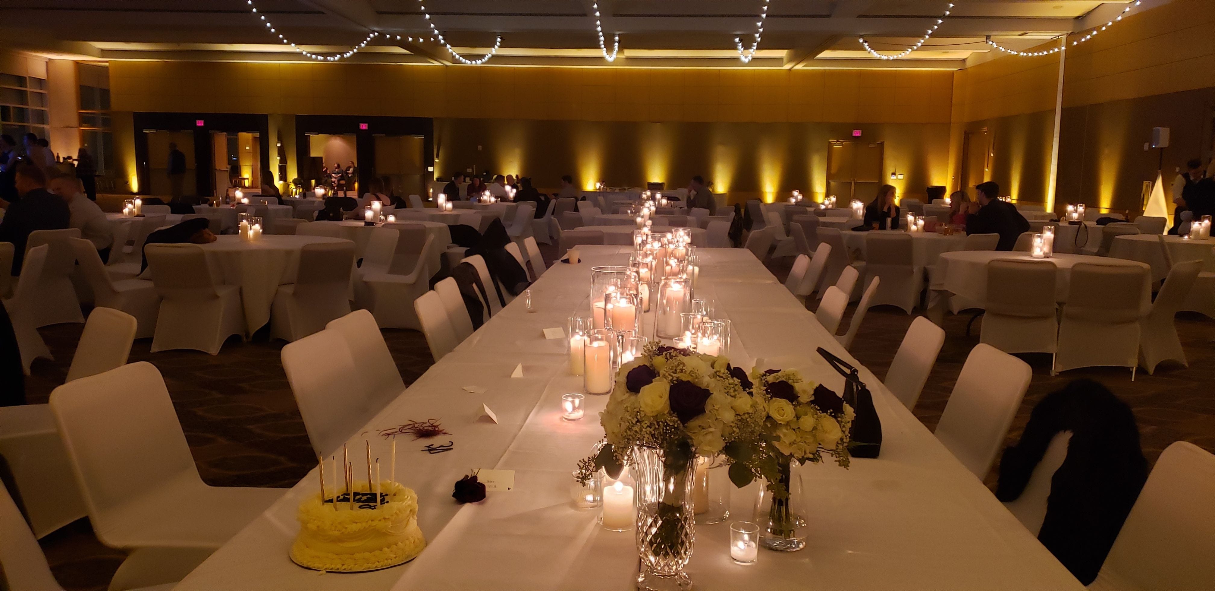 Wedding lighting in the Harbor Side Ballroom at the DECC. Up lighting in soft gold with bistro by Duluth Event Lighting.