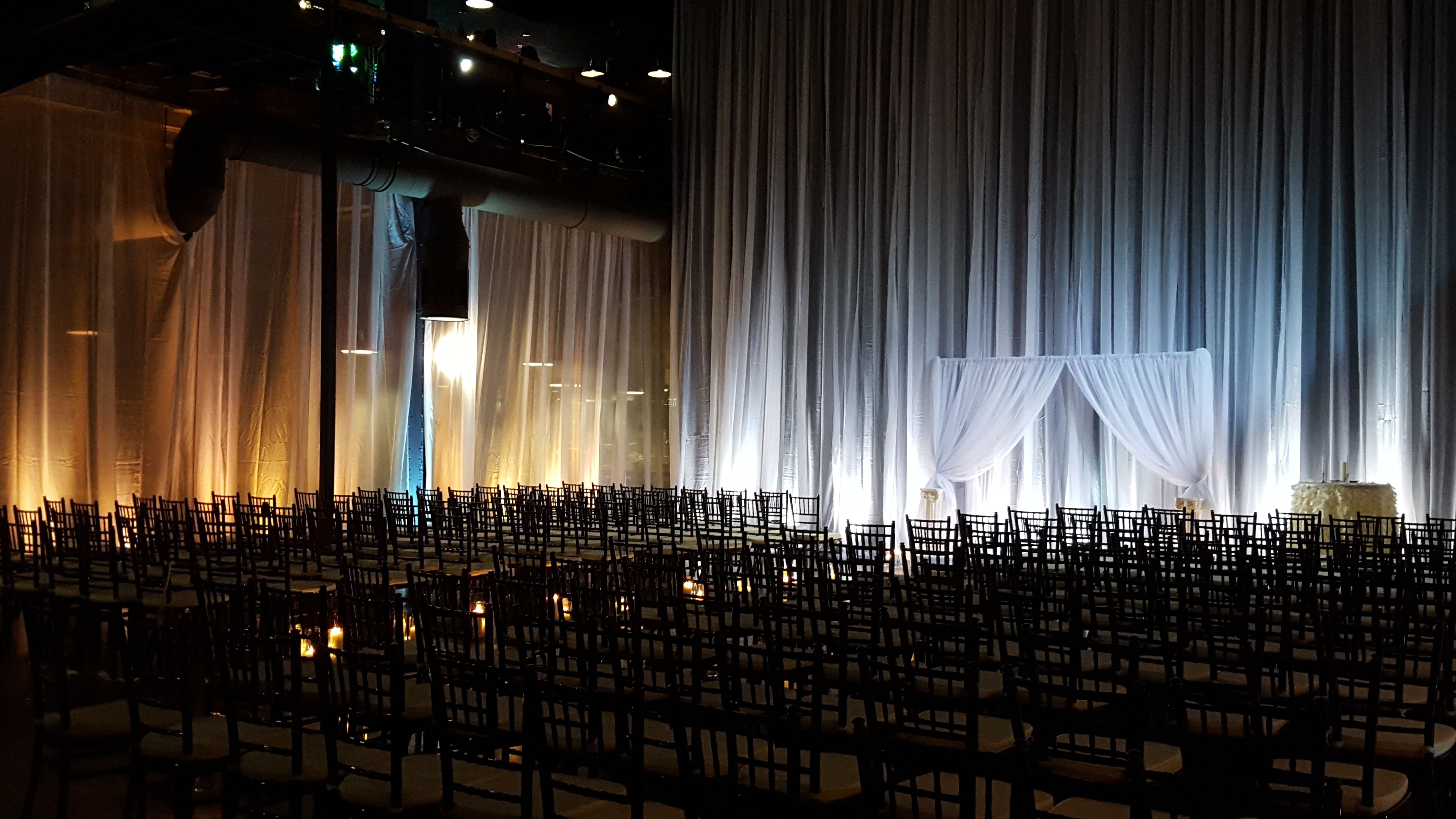 Wedding lighting at the Clyde Iron Works with tall pipe and drape with lighting.