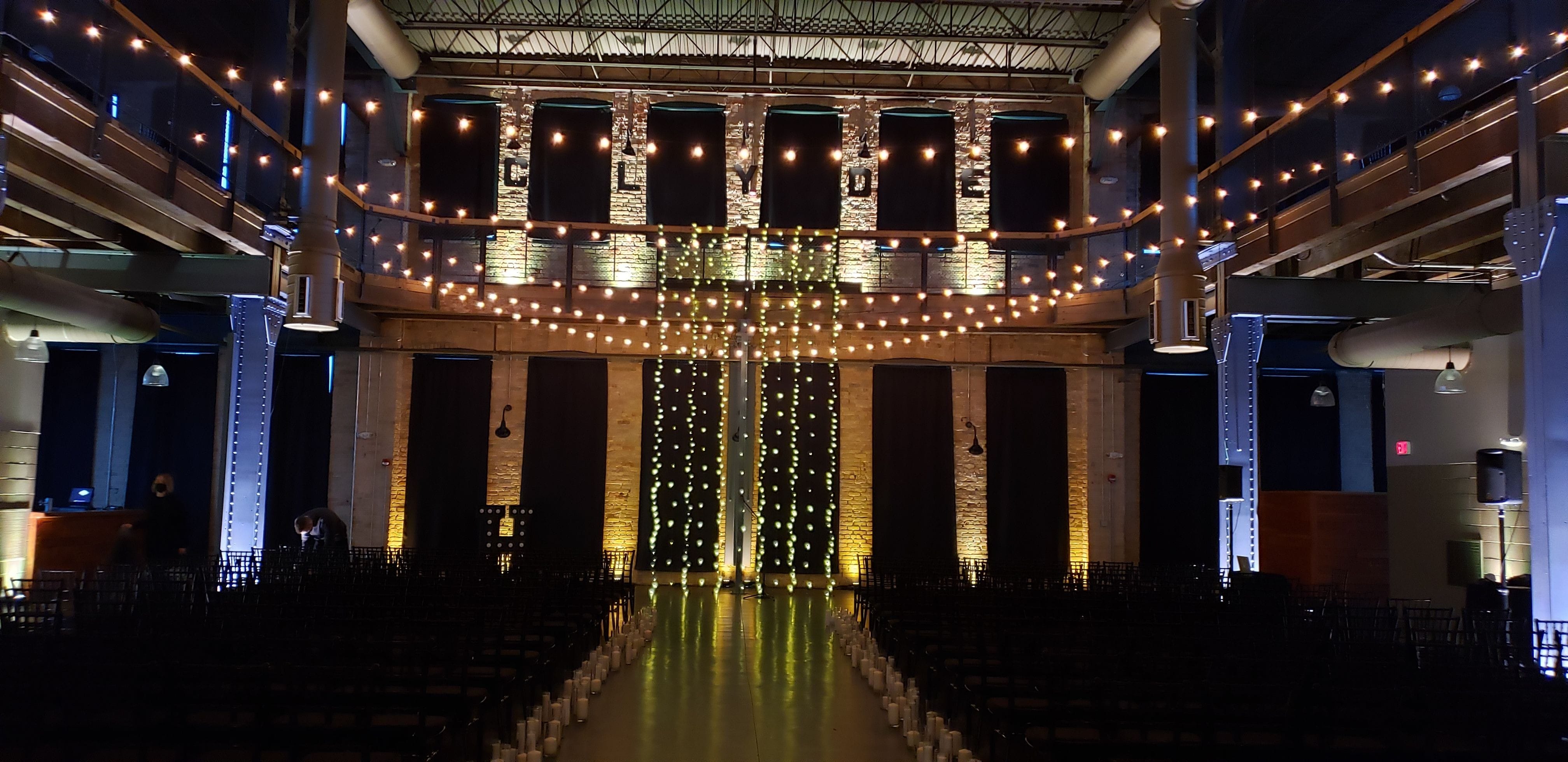 Wedding lighting at Clyde Iron Works with a bistro backdrop over the balcony.