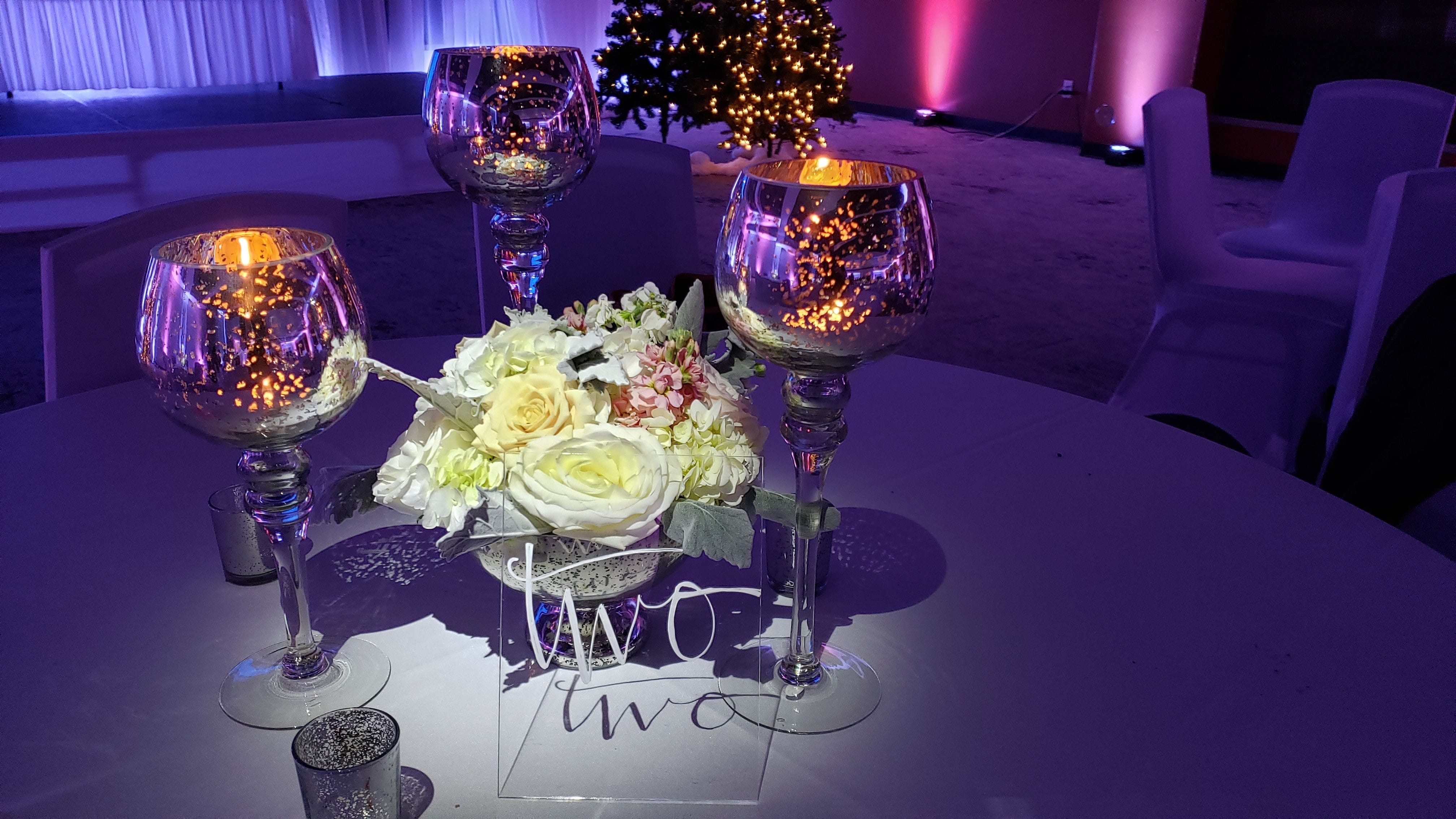 Wedding lighting at Pier B. Pin spot on the floral centerpeices.