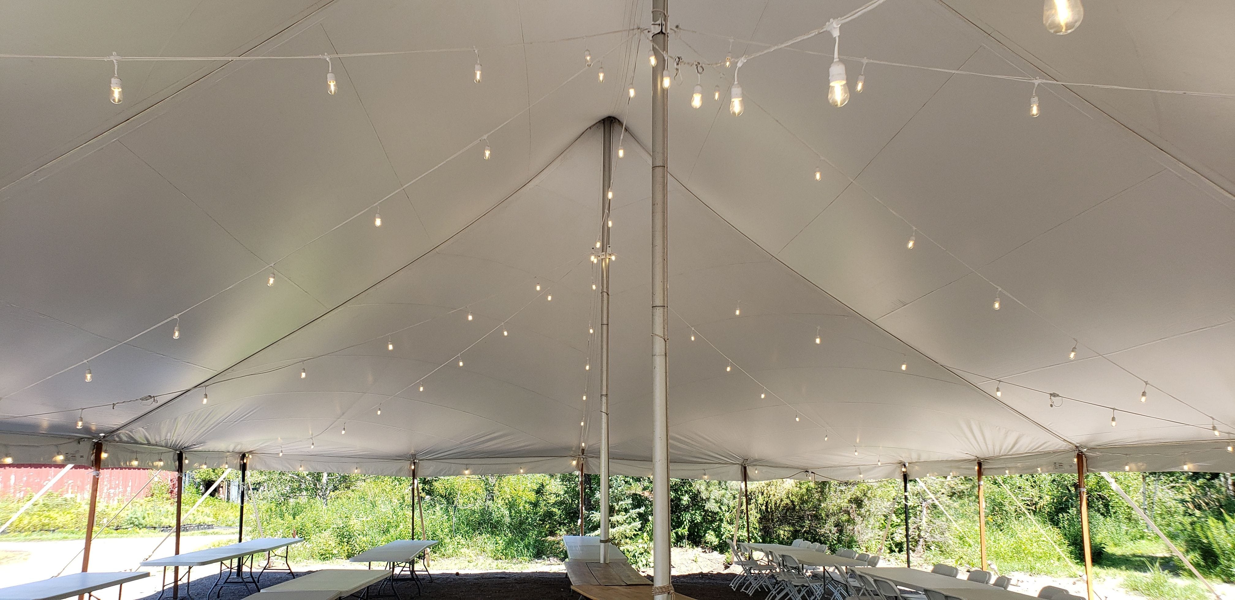 Tent wedding lighting with bistro at Sitio Events