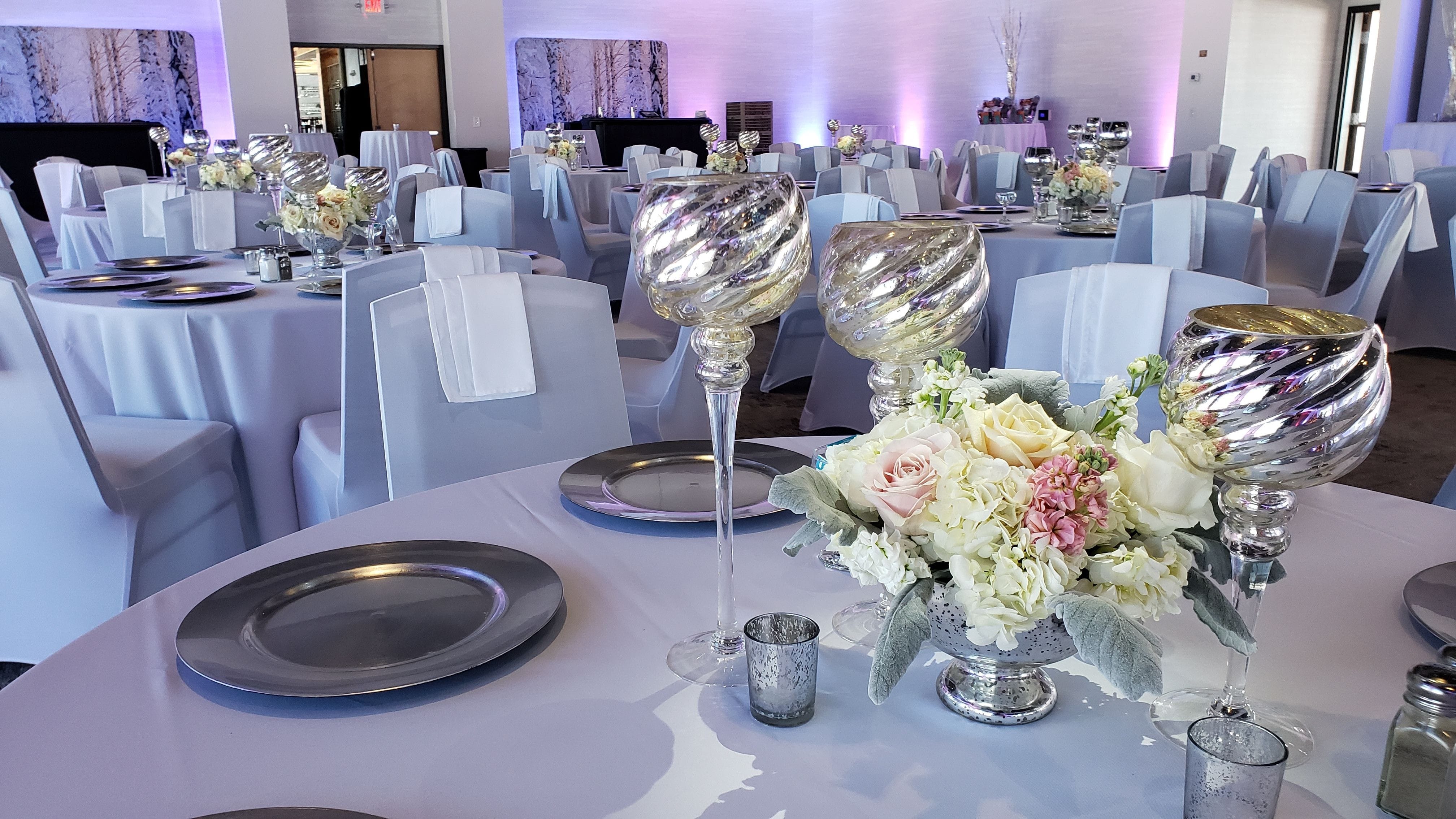 Pier B wedding lighting in two tone lavender. pin spots on flowers. decor by @thevaultduluth